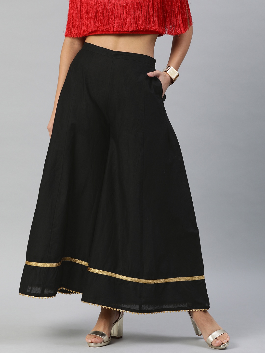 

Inddus Women Black Solid Flared Palazzos with Taping Detail
