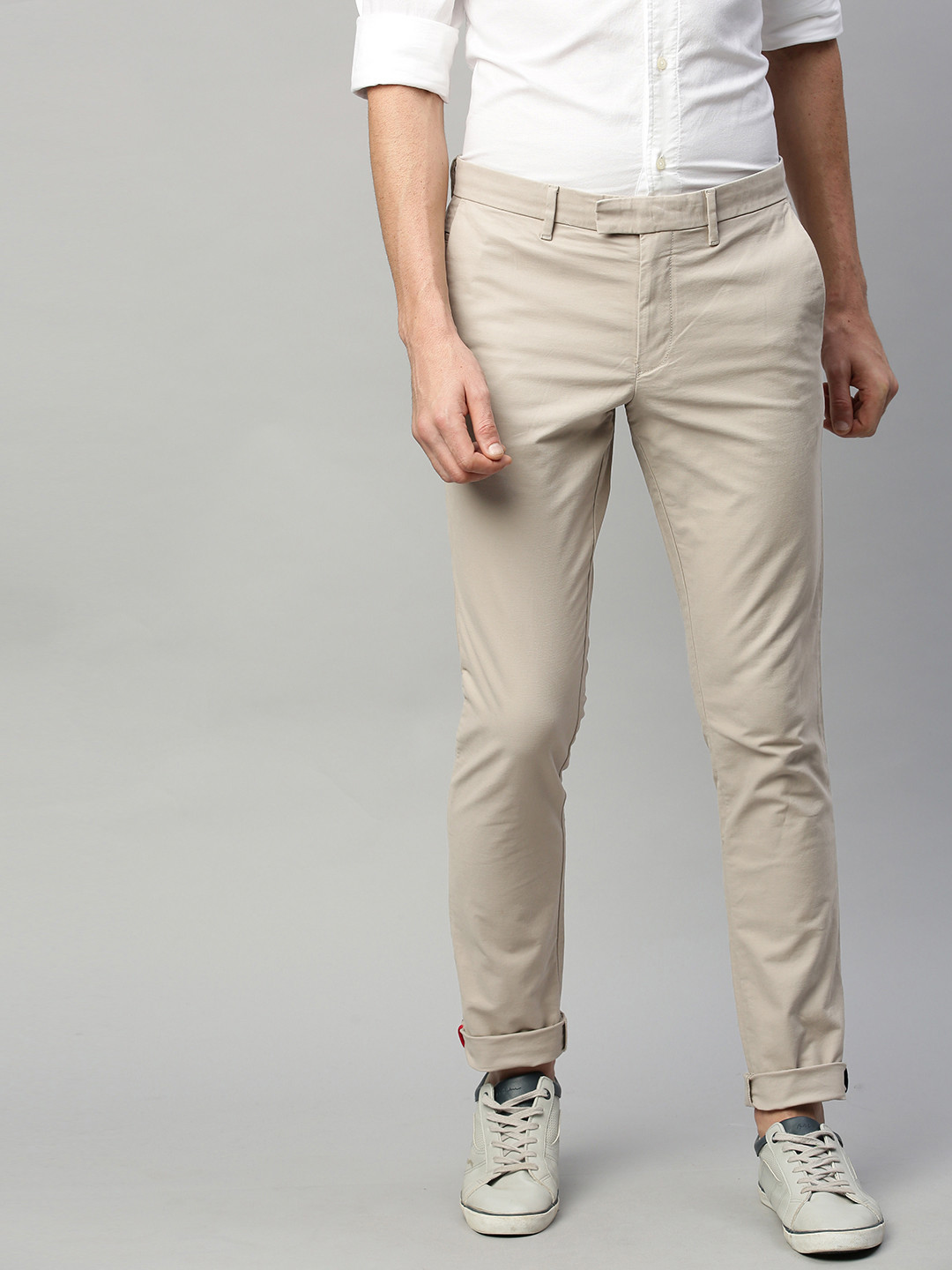

Tommy Hilfiger Men Beige Slim Fit Solid Regular Trousers