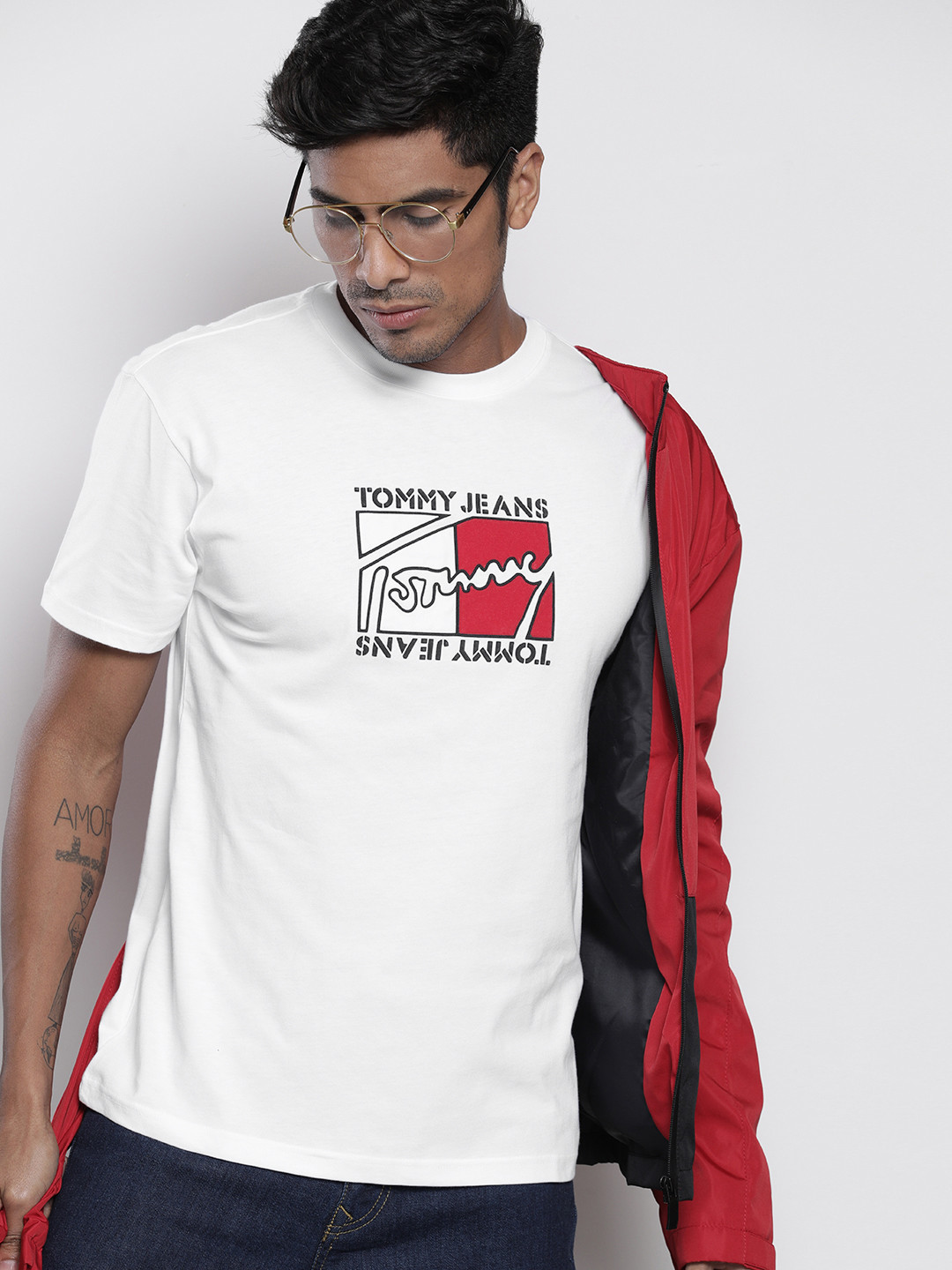 

Tommy Hilfiger Men White Solid Round Neck Pure Cotton T-shirt with Printed Detailing