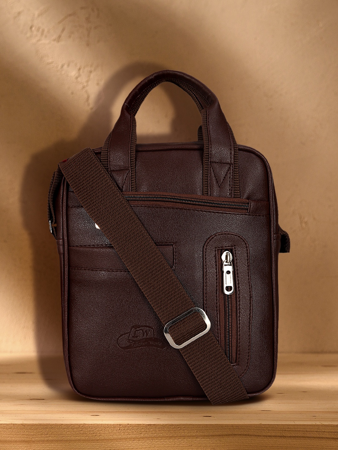 

Leather World Brown Solid Handheld Bag