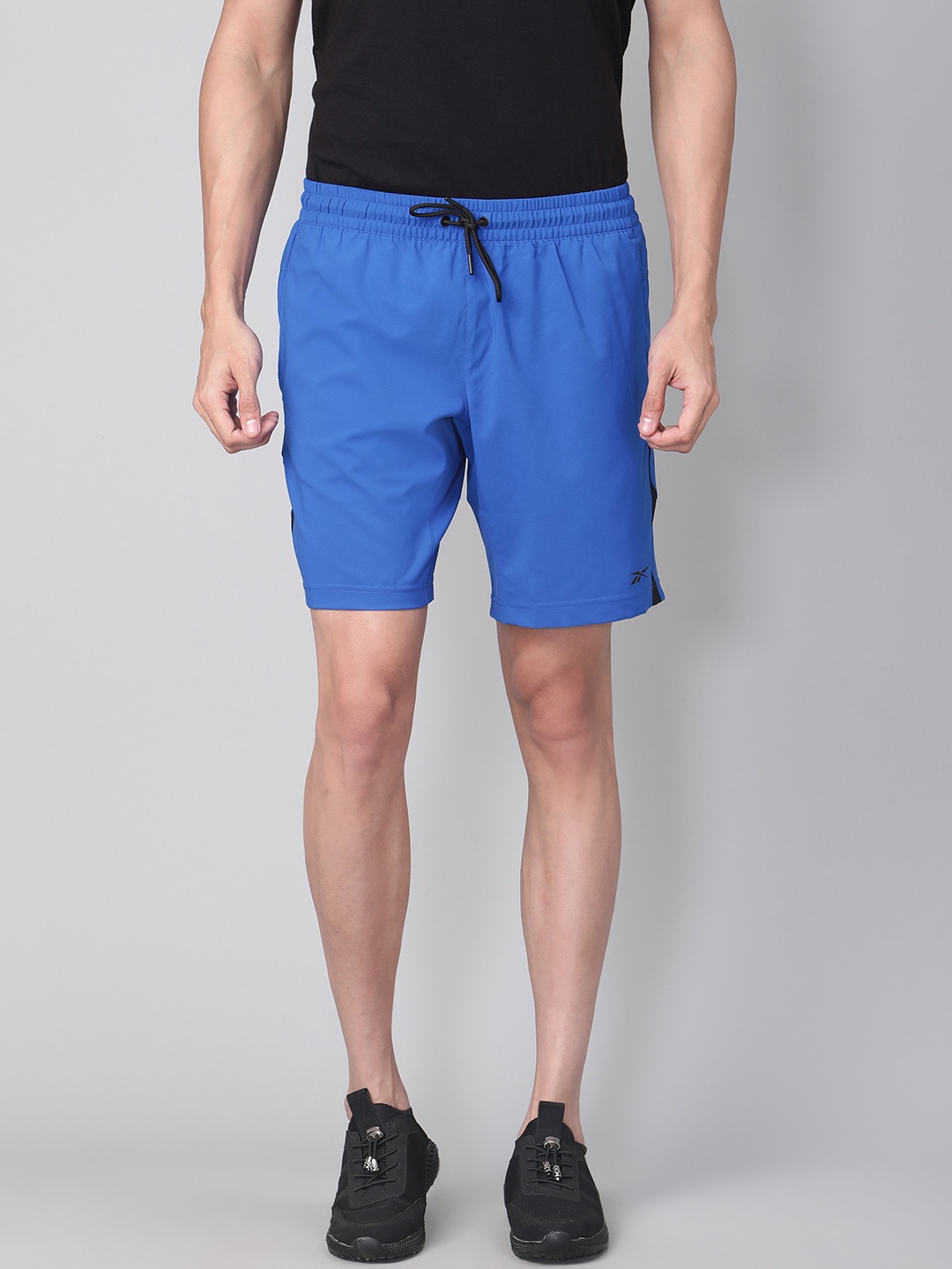 

Reebok Men Blue Training Wor Solid Woven Shorts