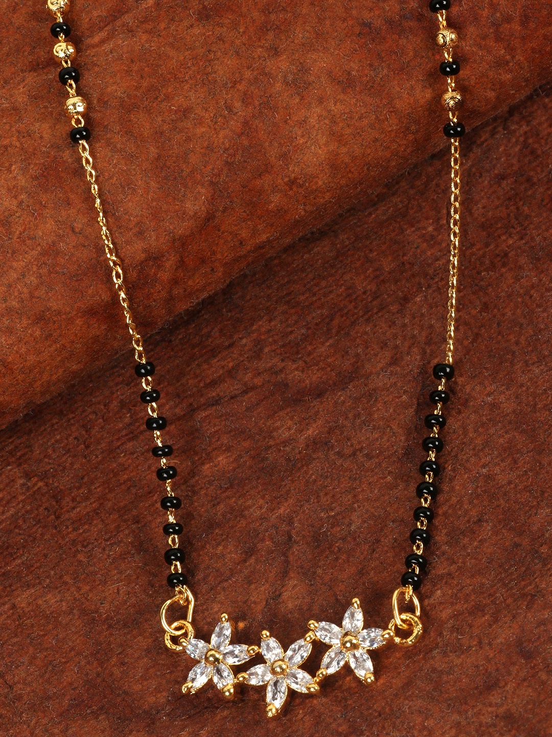 

JEWELS GEHNA Black Gold-Plated Beaded & AD Studded Floral Shaped Mangalsutra