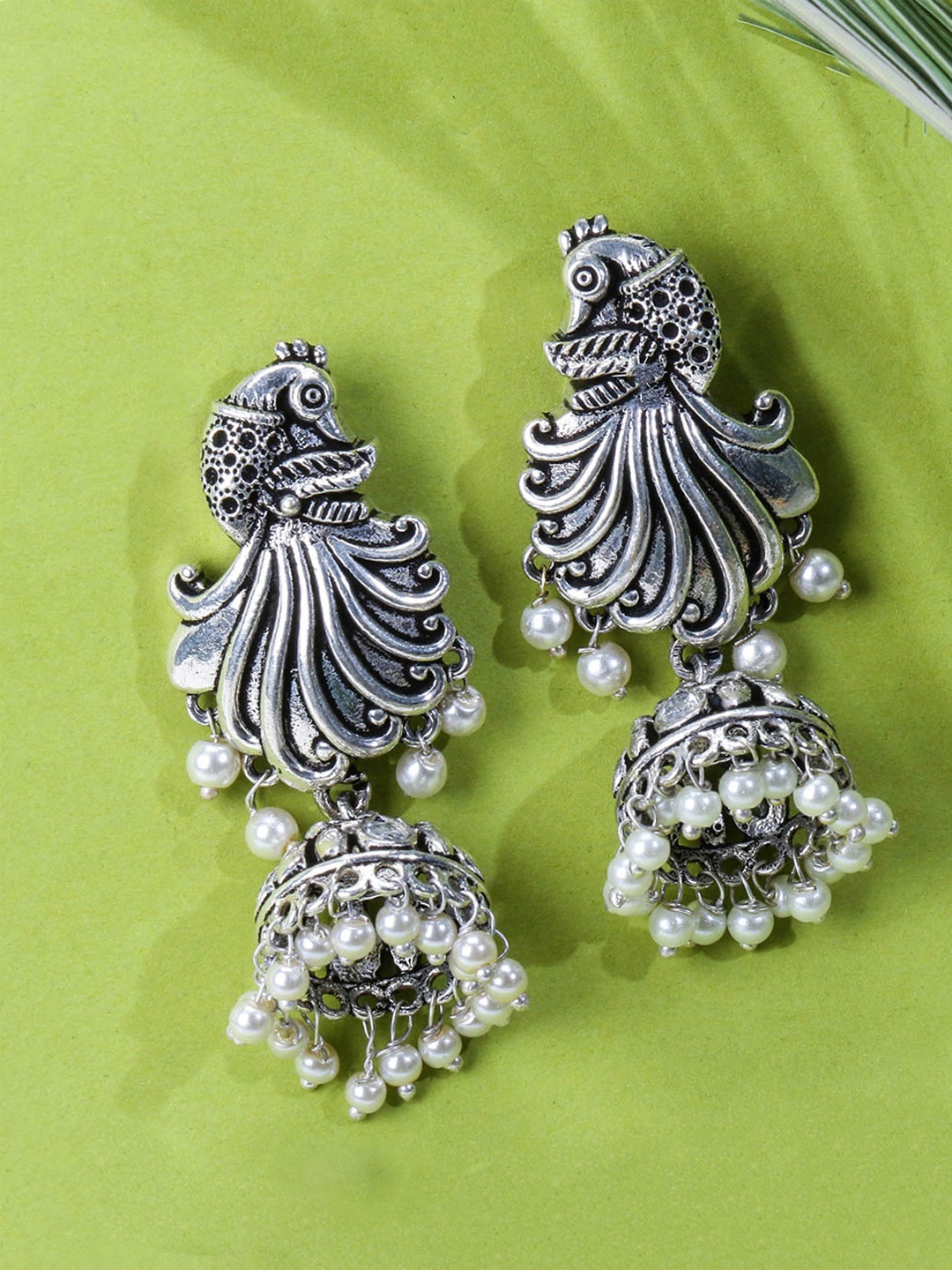 

Yellow Chimes Silver-Toned & White Silver Plated Peacock Shaped Jhumkas