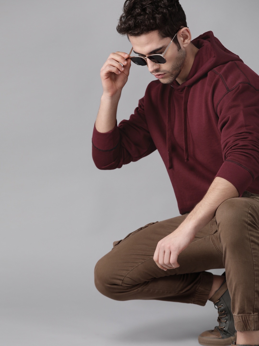 

Roadster Men Maroon Solid Hooded Sweatshirt