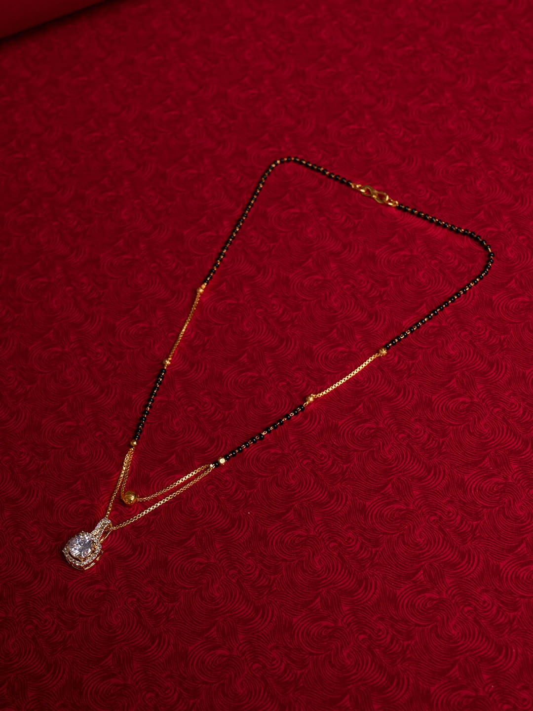 

Shoshaa Gold-Plated Black & White AD Stone-Studded & Beaded Mangalsutra