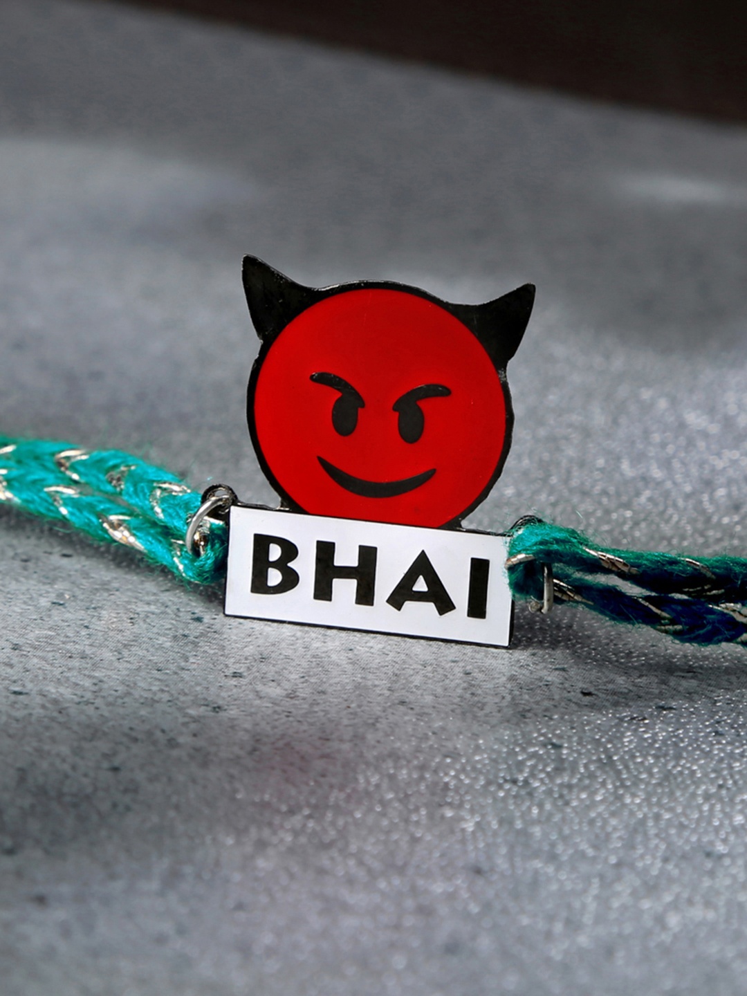 

Bigsmall Red & Green Devil Bhai Brass Sheet Embellished Rakhi