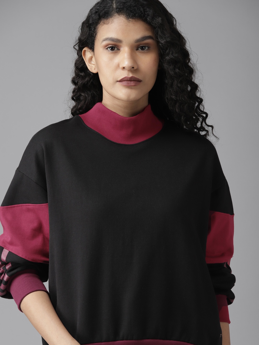 

Roadster Women Black & Magenta Solid Sweatshirt