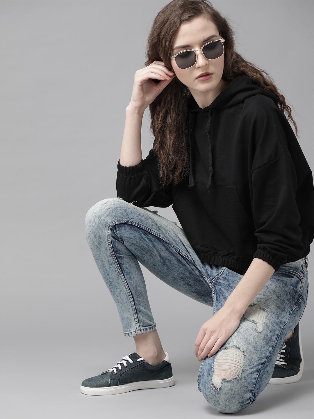 

Roadster Women Black Solid Hooded Sweatshirt