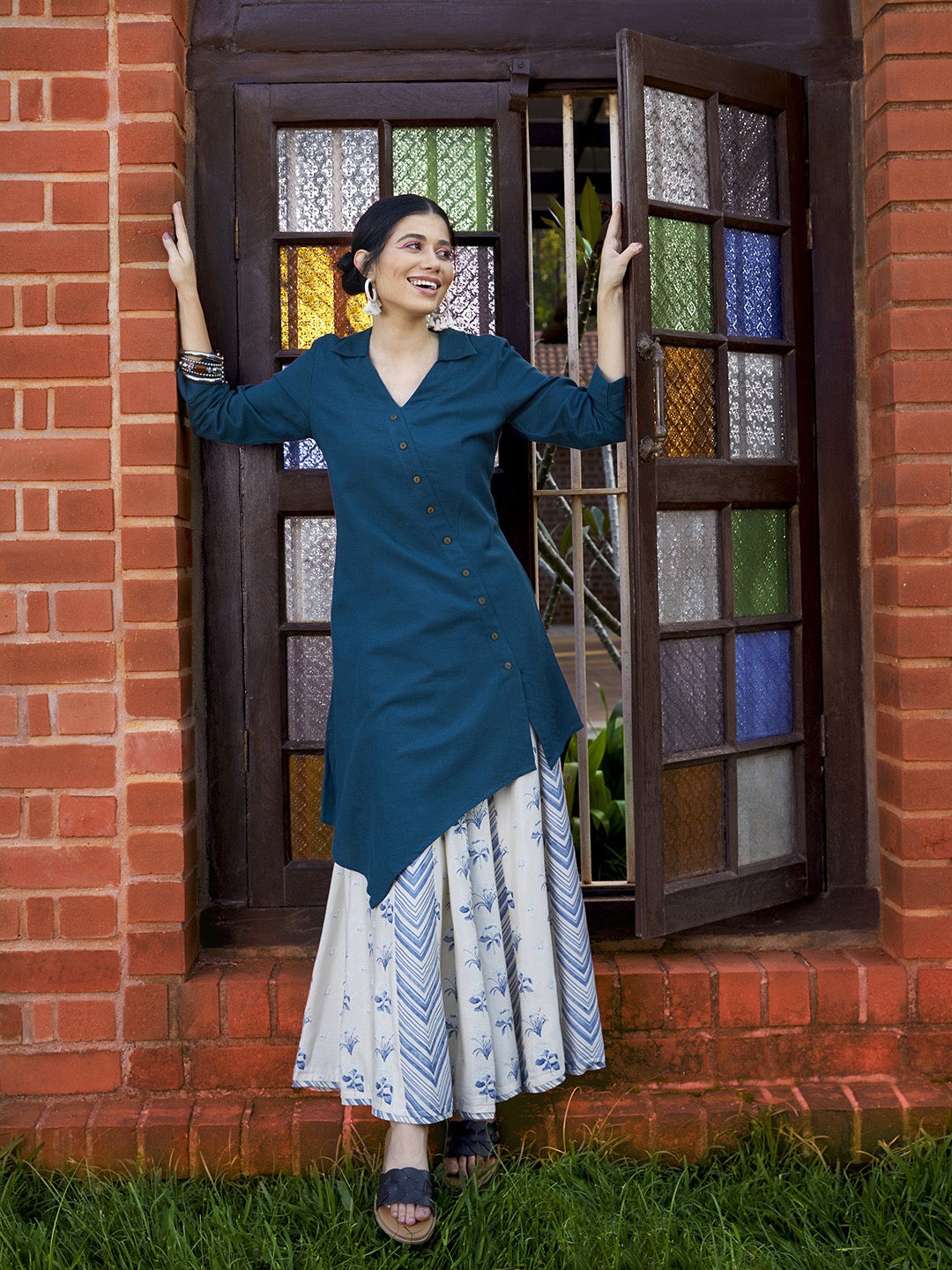 

Global Desi Women Teal Blue Solid Tunic with Asymmetric Hem