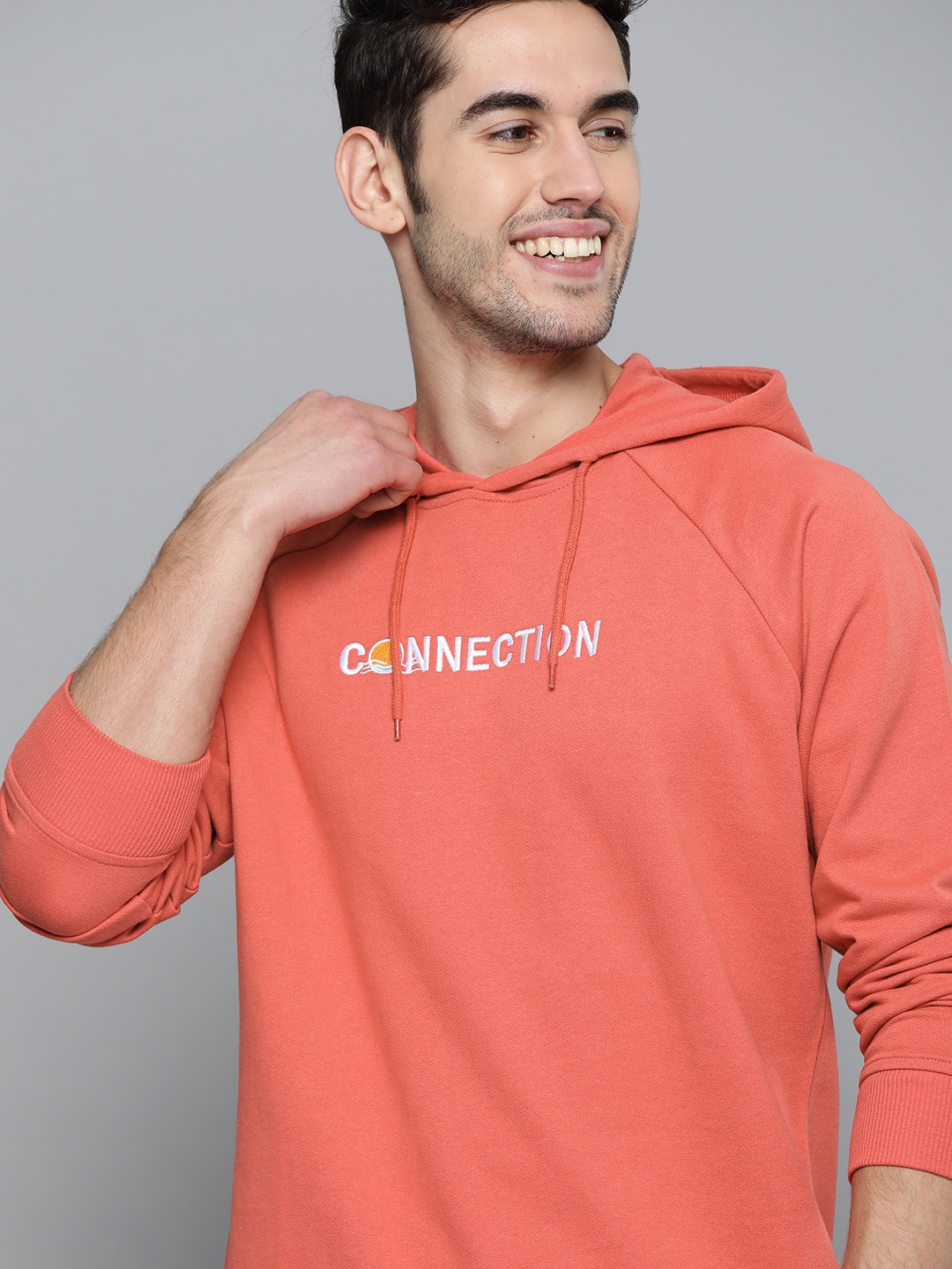 

Mast & Harbour Men Coral Pink Solid Hooded Sweatshirt