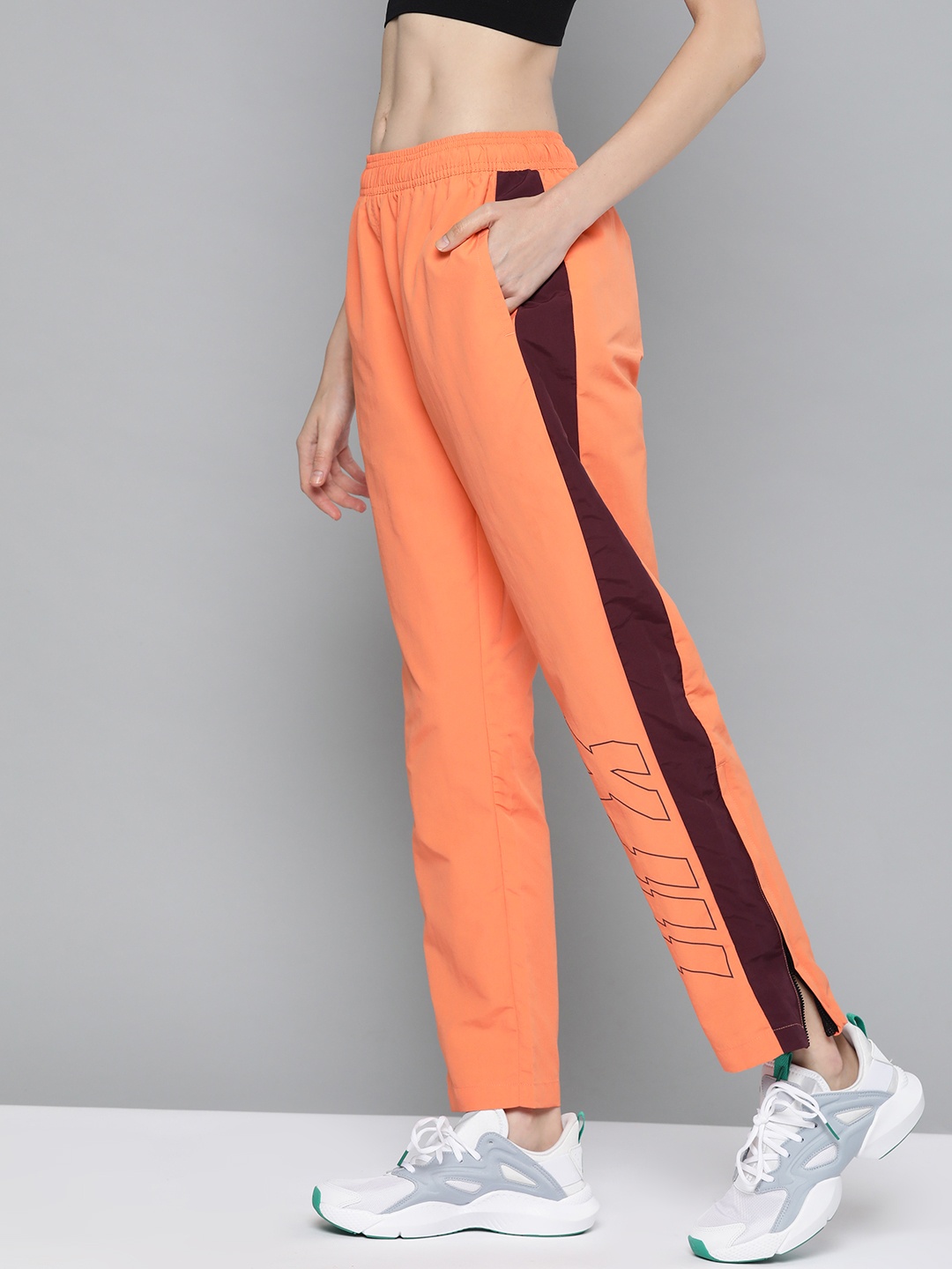 

HRX by Hrithik Roshan Women Solid Regular Fit Antimicrobial Lifestyle Track Pants, Orange