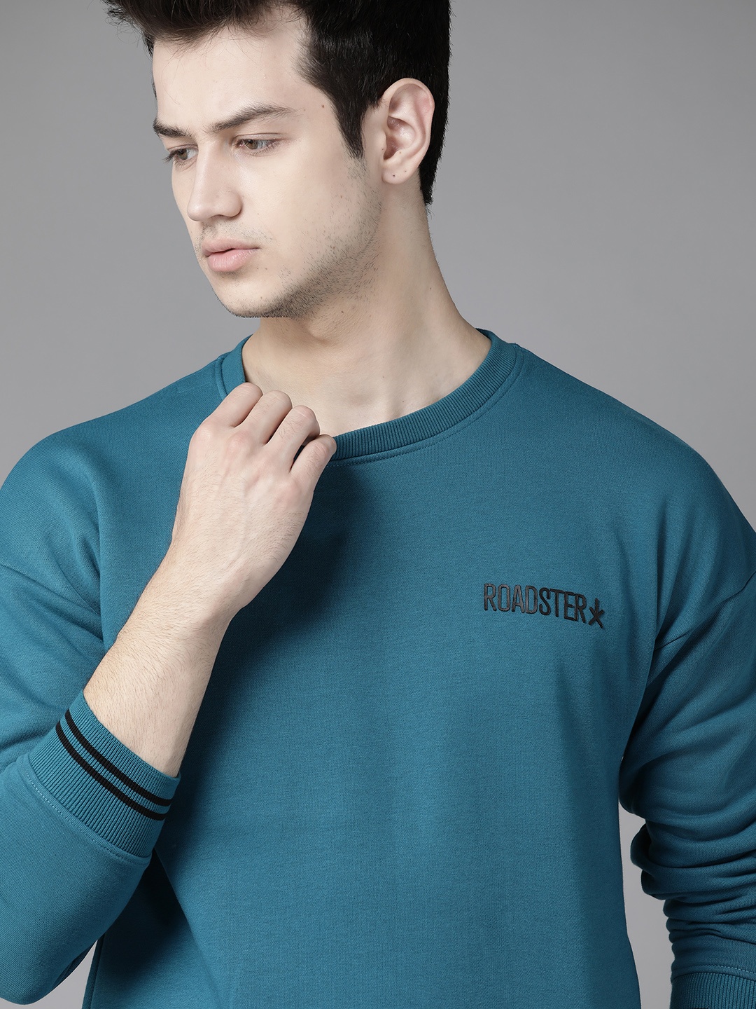 

Roadster Men Teal Blue Solid Sweatshirt