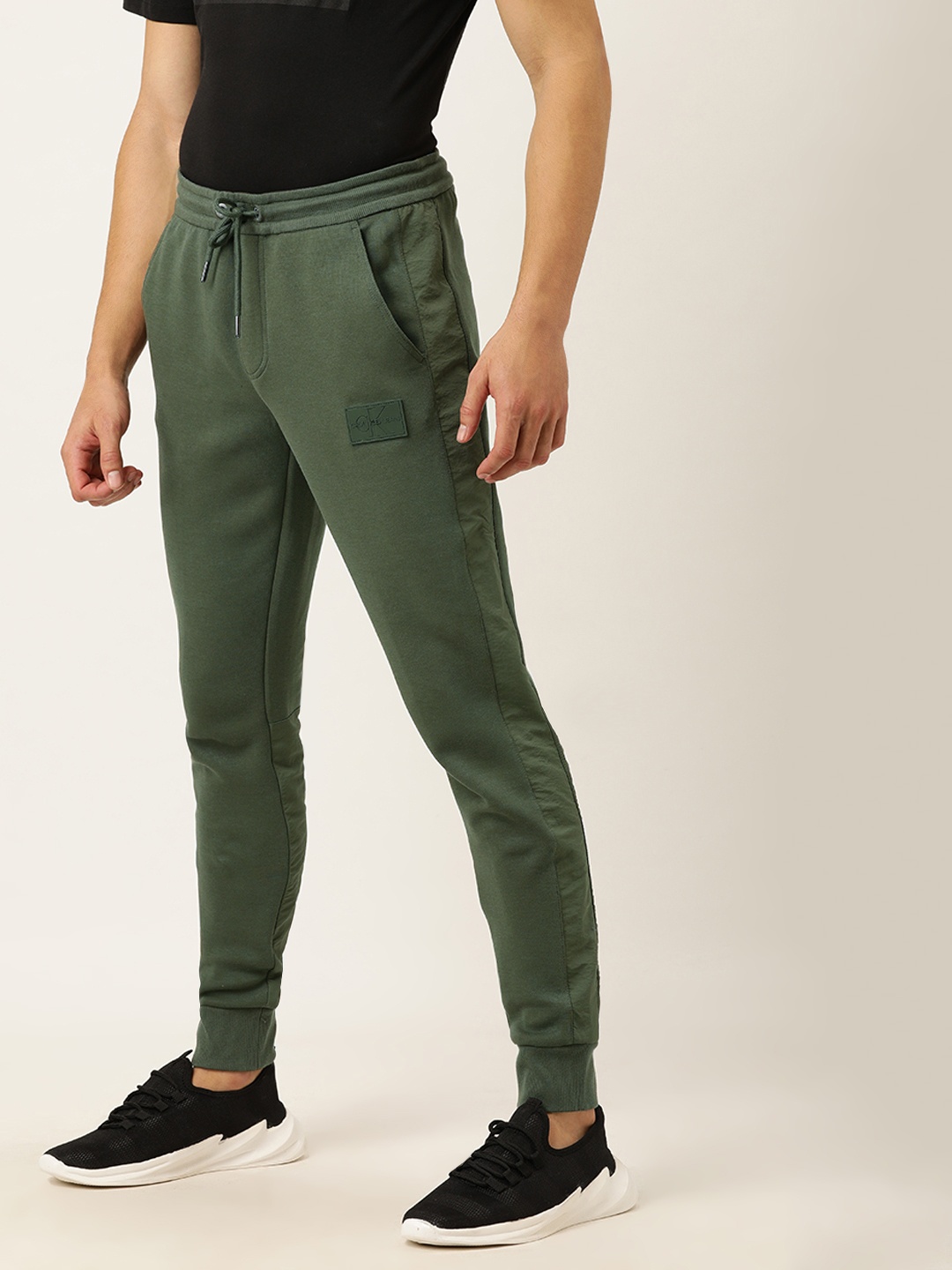 

Calvin Klein Jeans Men Olive Green Straight Fit Solid Joggers with Side Stripes
