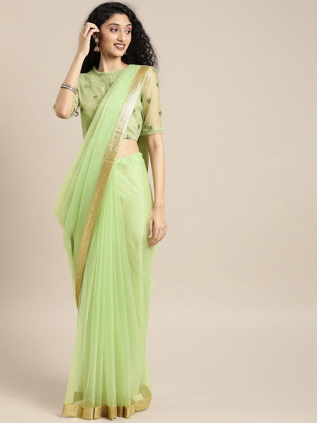 

Inddus Green Solid Net Saree with Sequinned Border