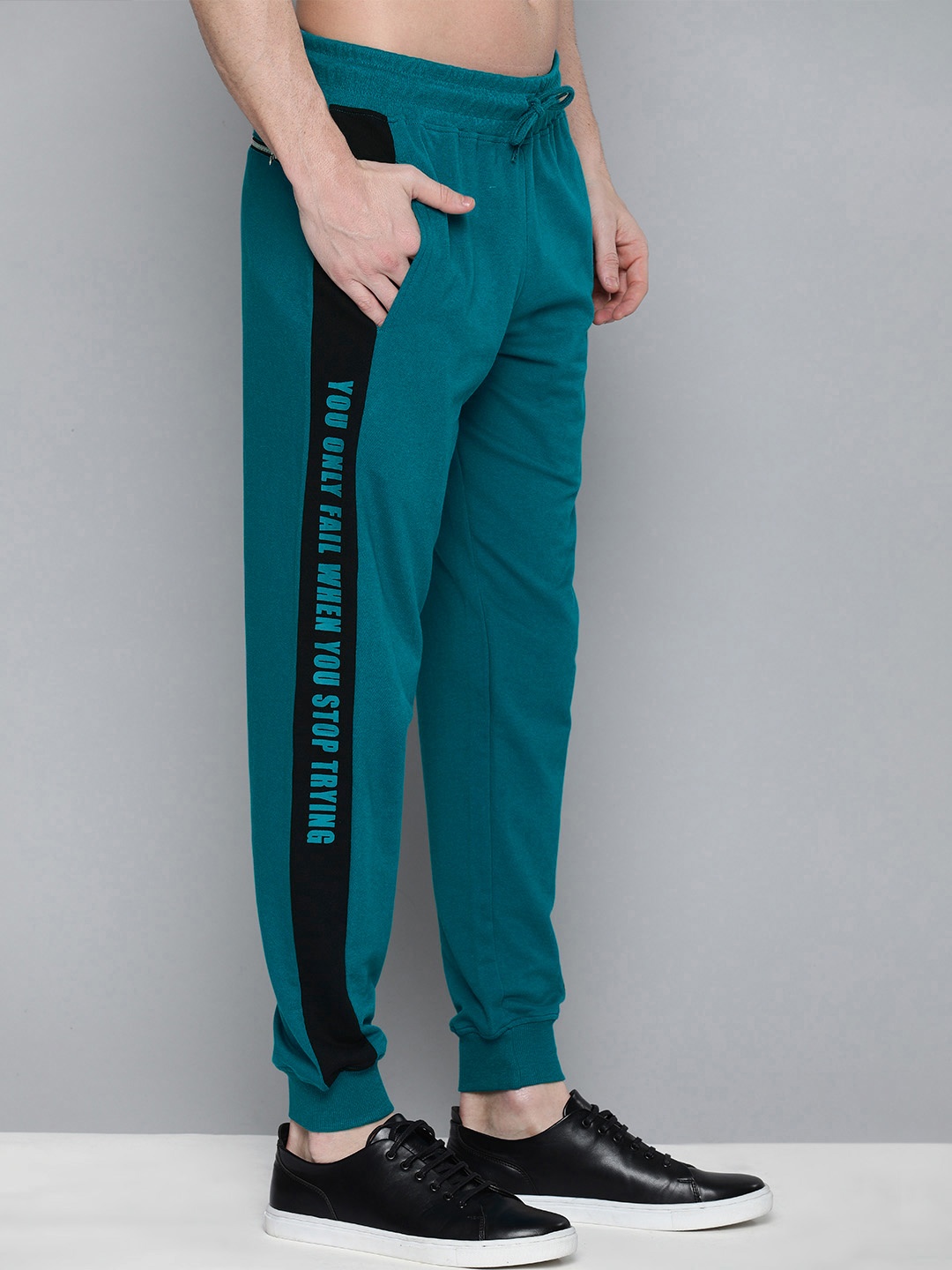 

HERE&NOW Men Teal Blue Solid Regular Fit Joggers with Printed Details