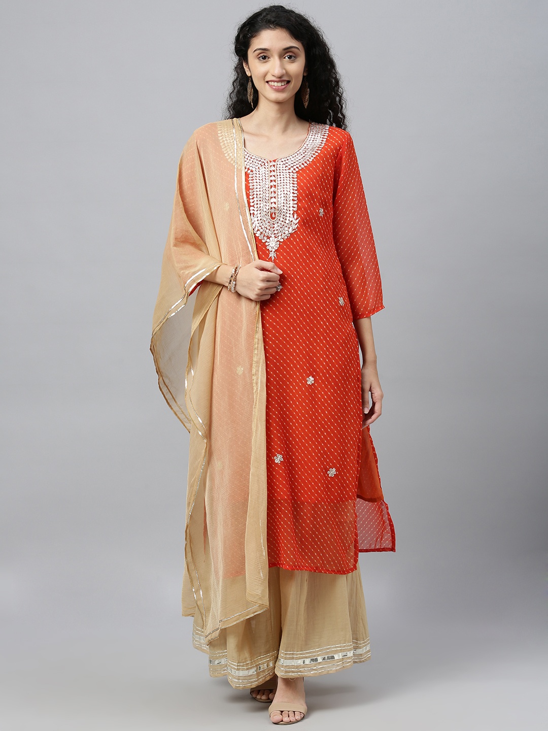 

Geroo Jaipur Orange Hand dyed Leheriya Georgette Kurta with Beige Palazzo & Dupatta