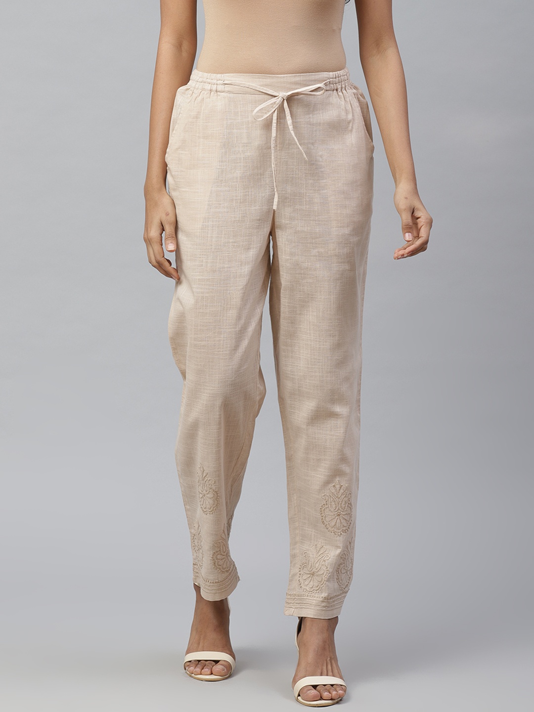 

akheri Women Beige Tapered Fit Embroidered Detail Regular Trousers