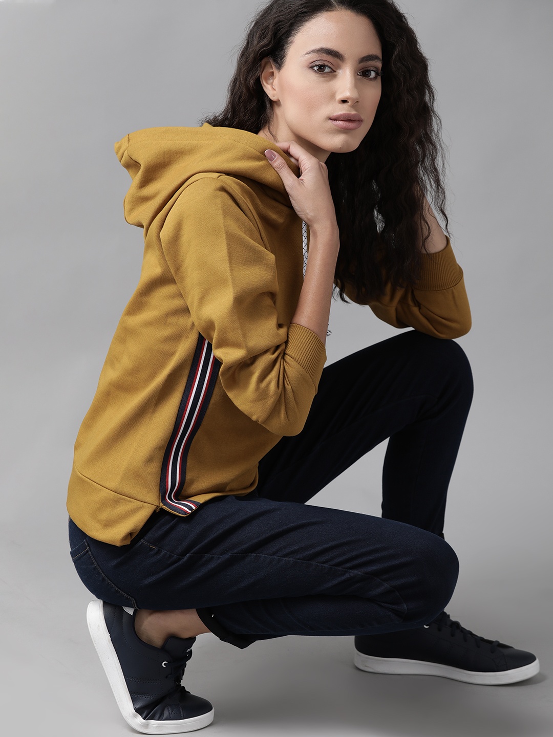 

Roadster Women Mustard Yellow Solid Hooded Sweatshirt