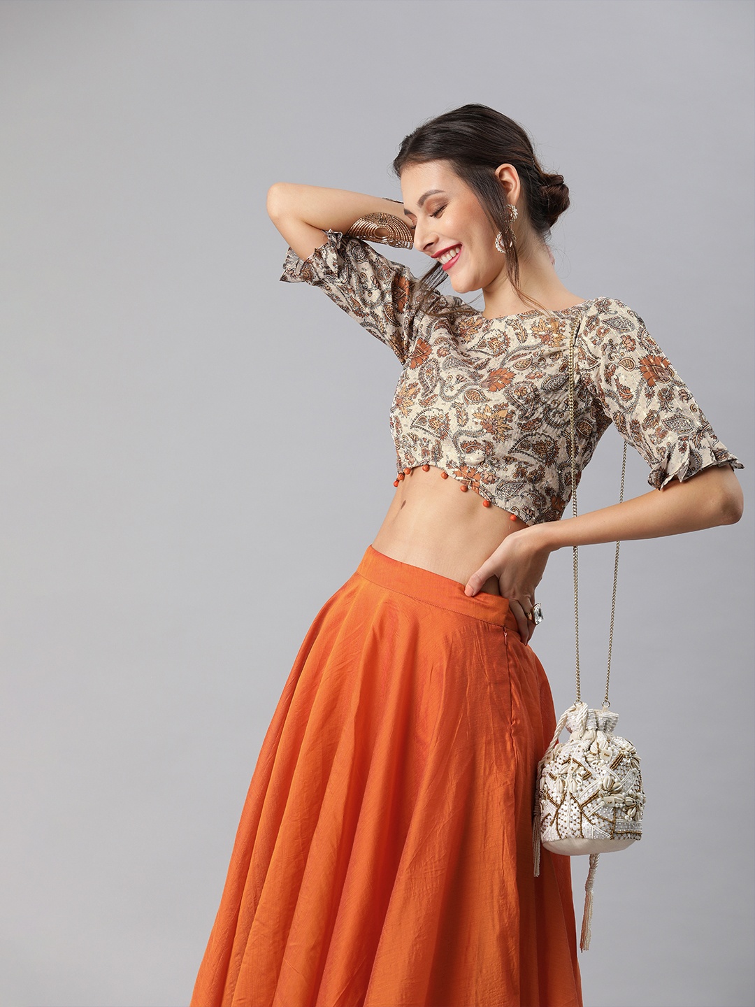 

Inddus Women Beige & Orange Printed Embellished Detail Crop Top with Skirt