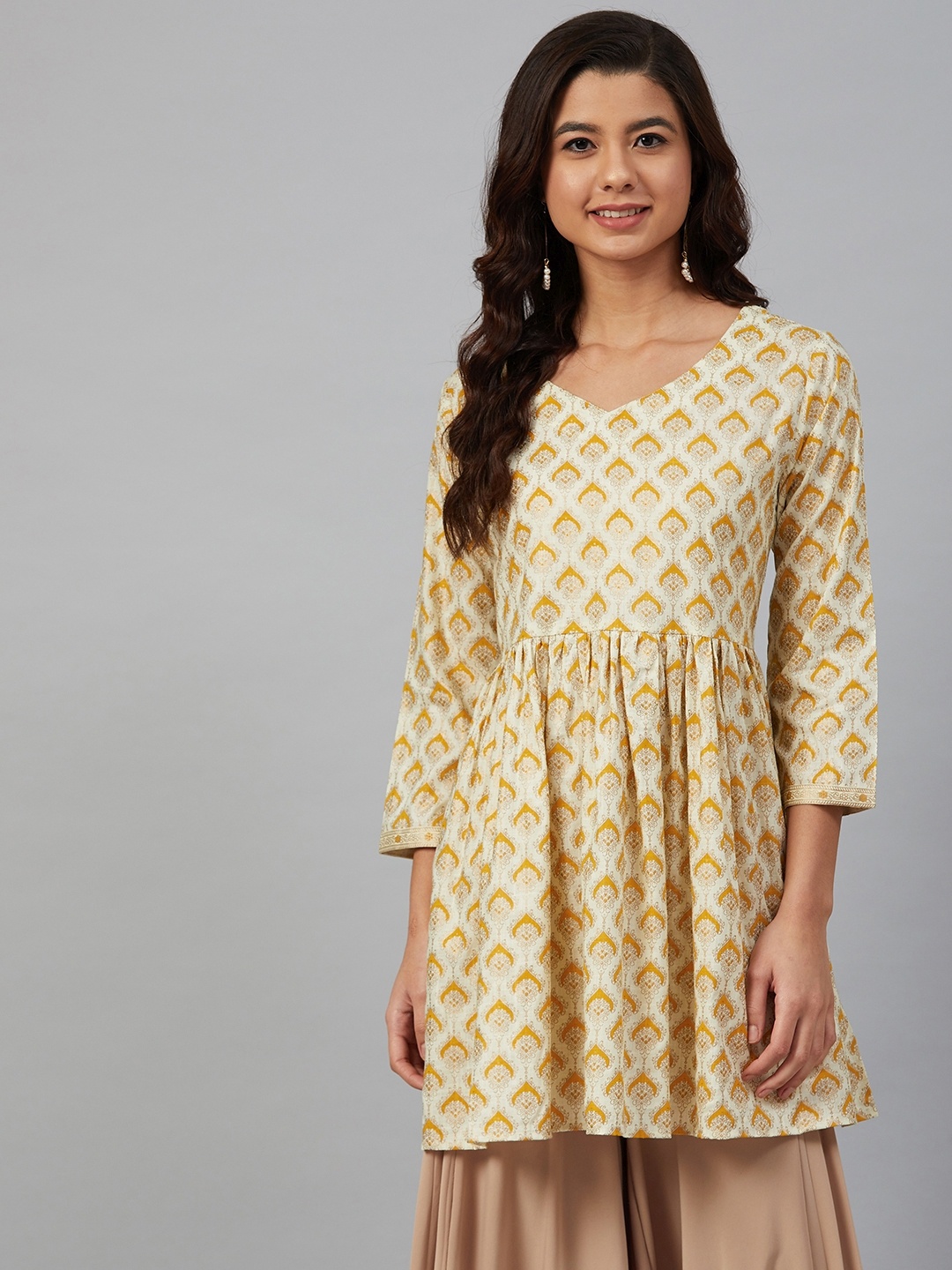 

Meeranshi Women Cream-Coloured & Mustard Yellow Printed A-Line Kurti