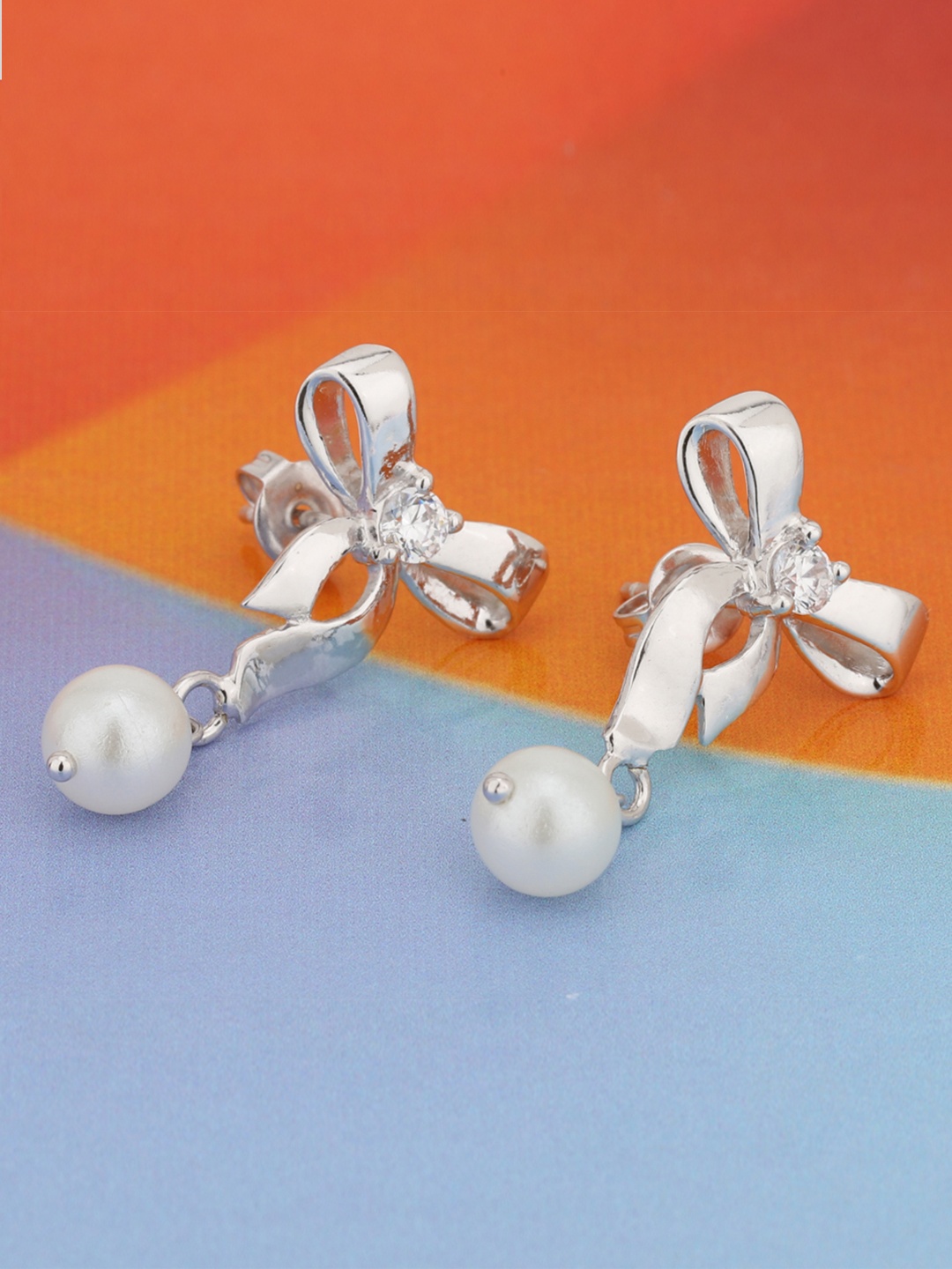 

Carlton London Silver-Toned & White Rhodium-Plated Stone-Studded Bow-Shaped Drop Earrings