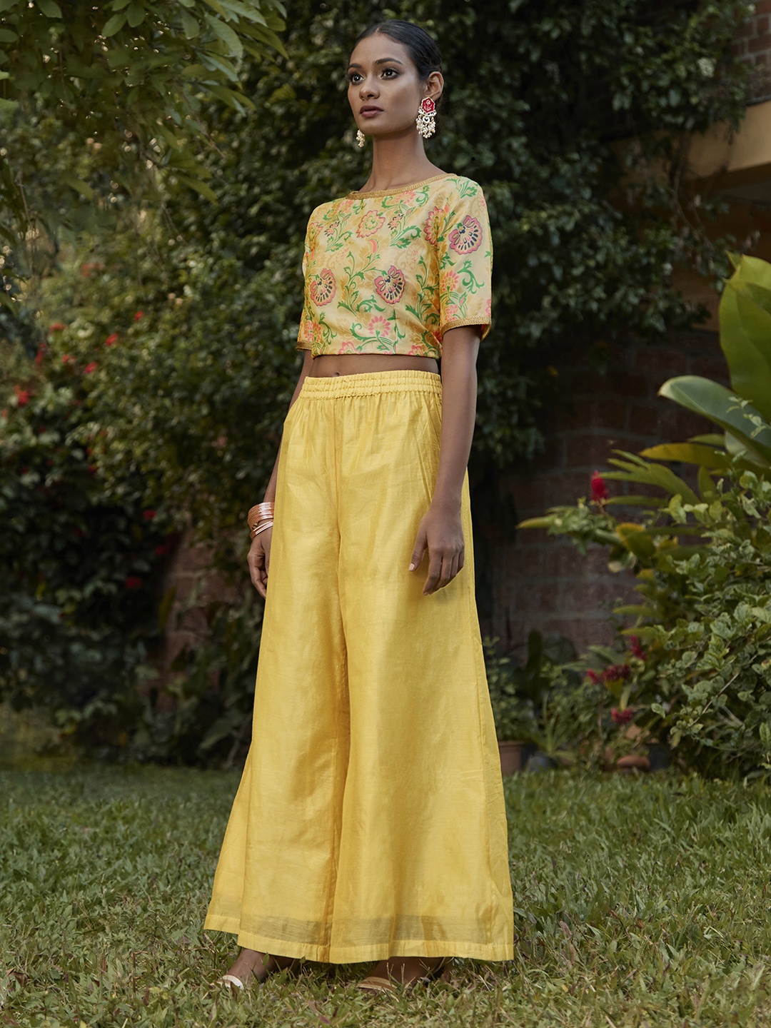 

Vishudh Women Yellow Solid Flared Palazzos