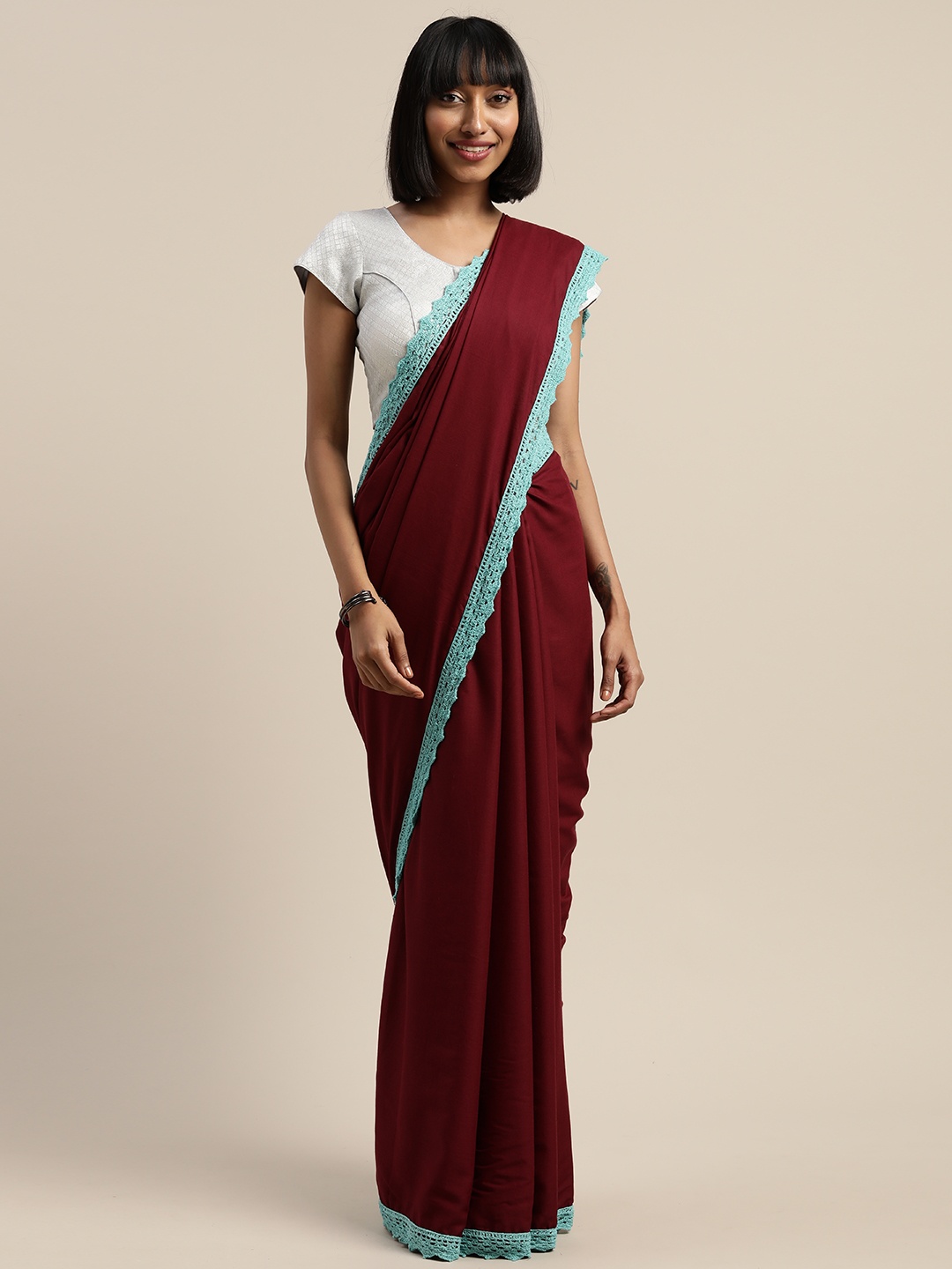 

Mitera Maroon & Blue Liva Solid Saree