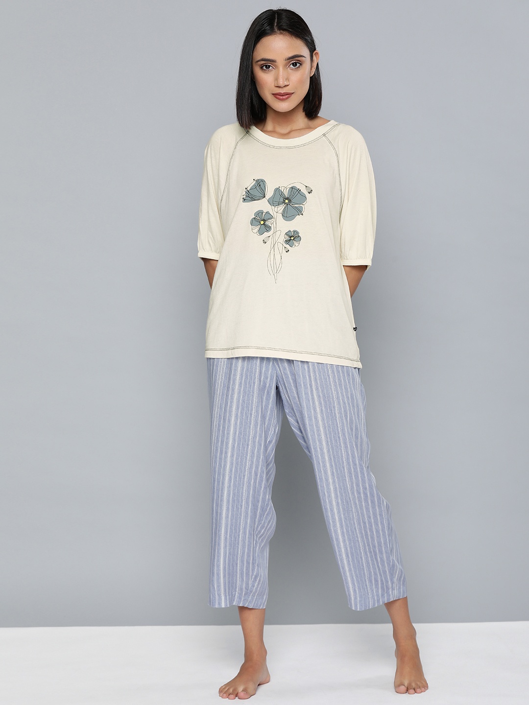

Chemistry Women Cream-Coloured Printed Tshirt & Blue Striped Capri Night suit