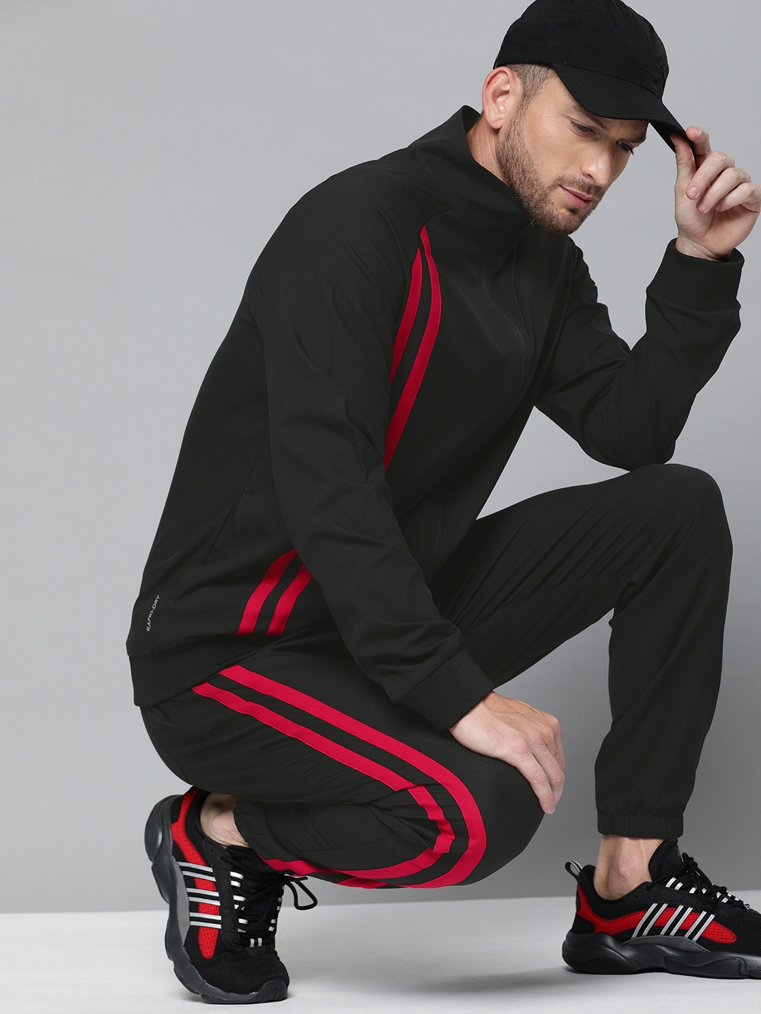 

HRX By Hrithik Roshan Men Jet Black & Barbados Cherry Colourblock Regular Fit Rapid-Dry Lifestyle Tracksuits