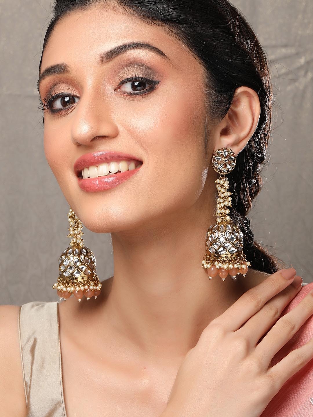 

Rubans Handcrafted 22K Gold Plated Kundan Studded Jhumka Earrings with Peach & Pearl Beads