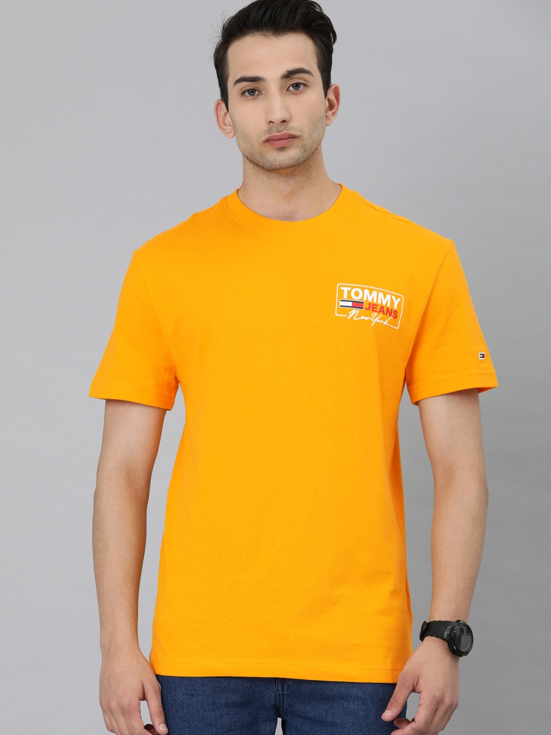 

Tommy Hilfiger Men Orange Solid Round Neck Pure Cotton T-shirt with Printed Detail