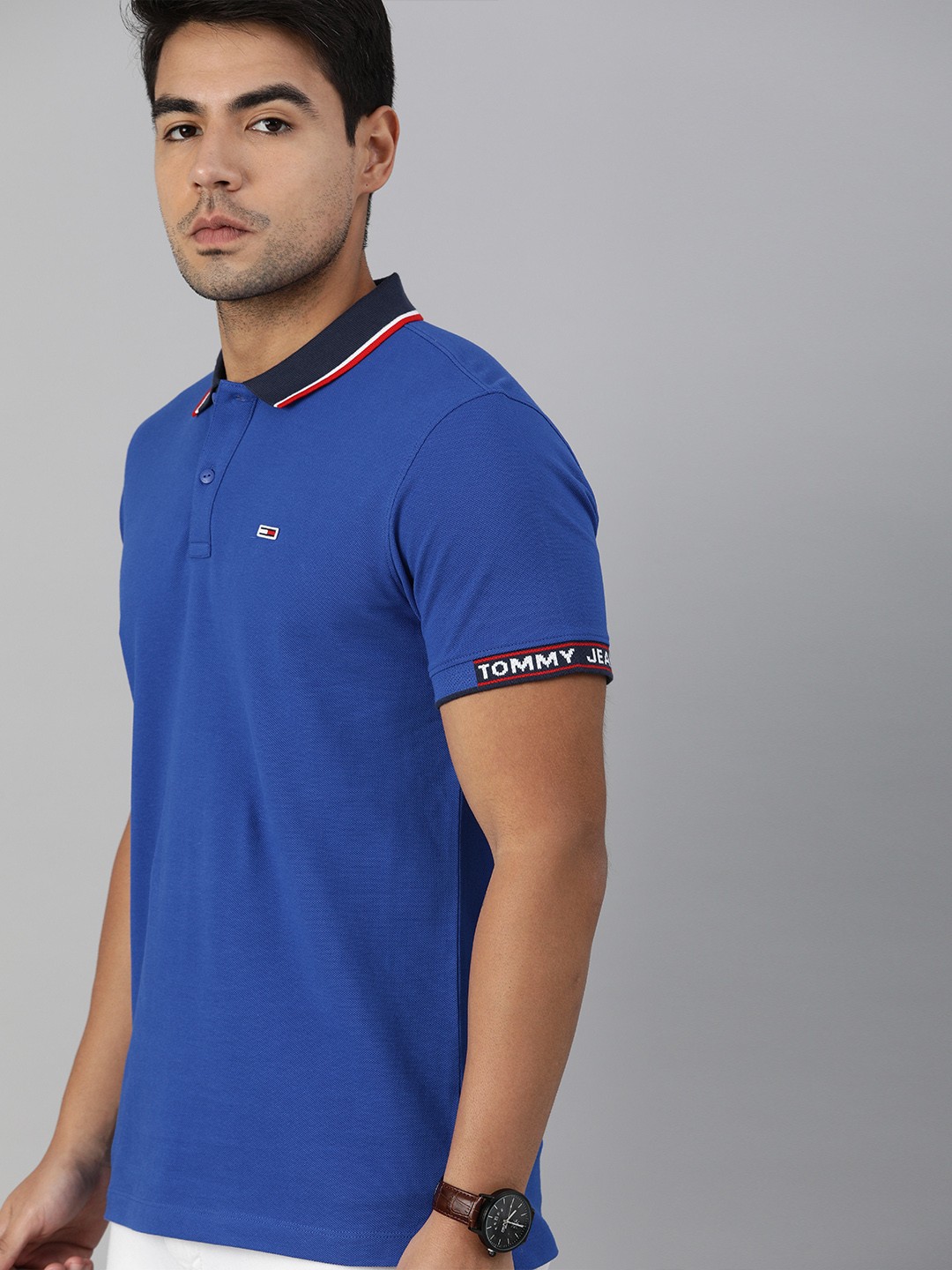 

Tommy Hilfiger Men Blue Solid Polo Collar Pure Cotton T-shirt with Logo Print Detailing