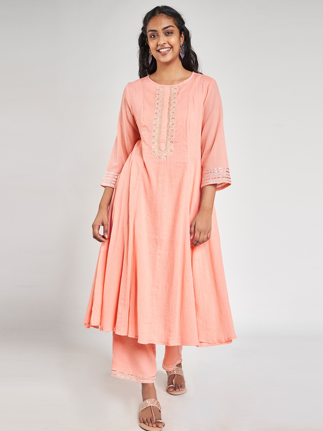 

Global Desi Women Peach Yoke Design Thread Work Kurta with Palazzos