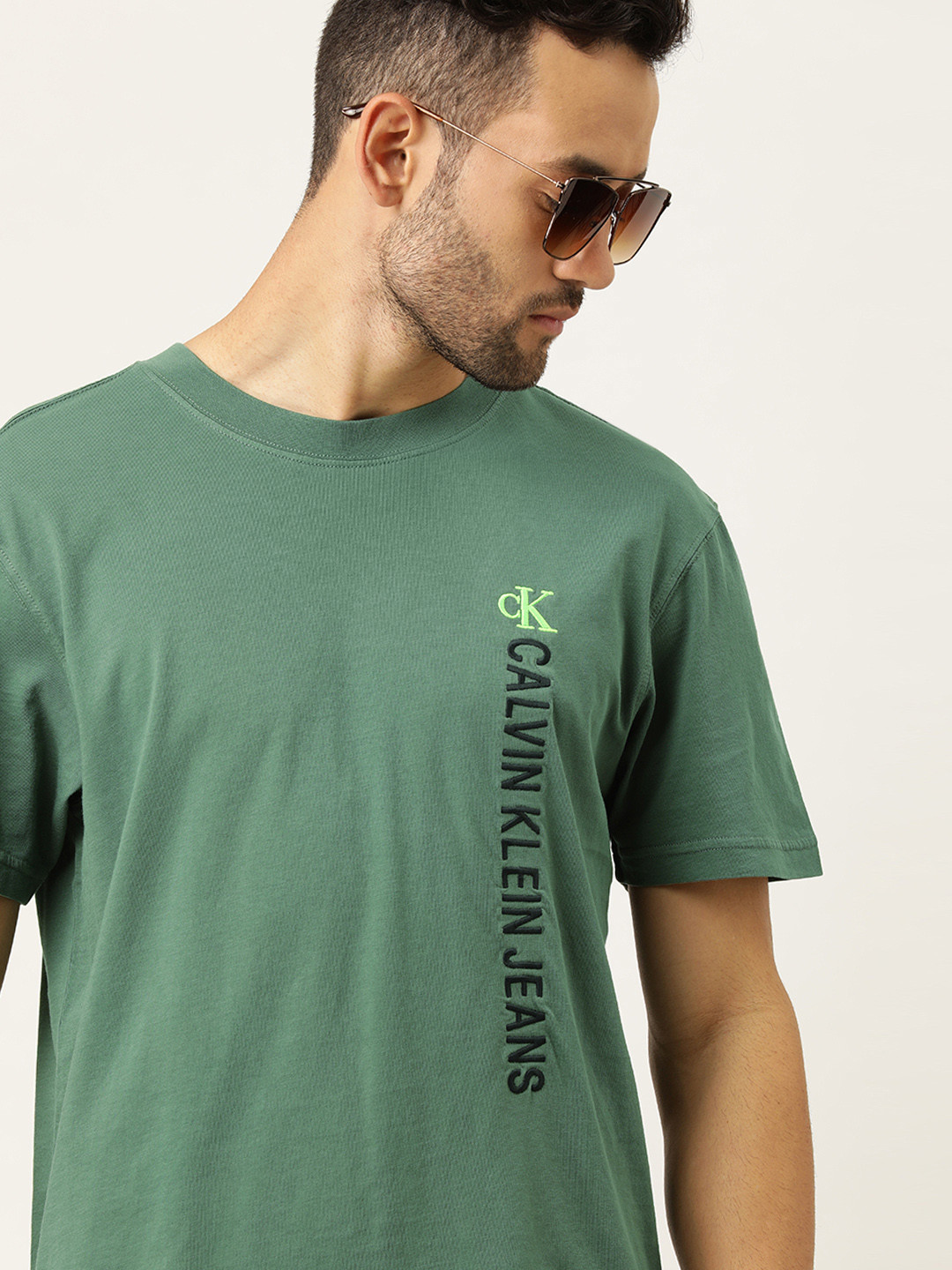 

Calvin Klein Jeans Men Green Solid Round Neck Pure Cotton T-shirt with Logo Detailing