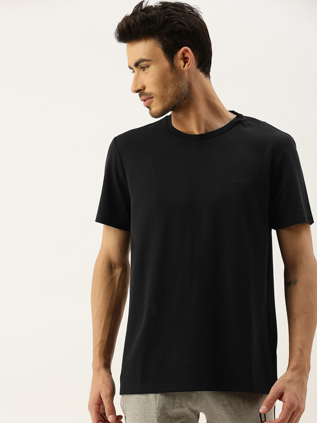 

Calvin Klein Jeans Men Black Solid Round Neck T-shirt