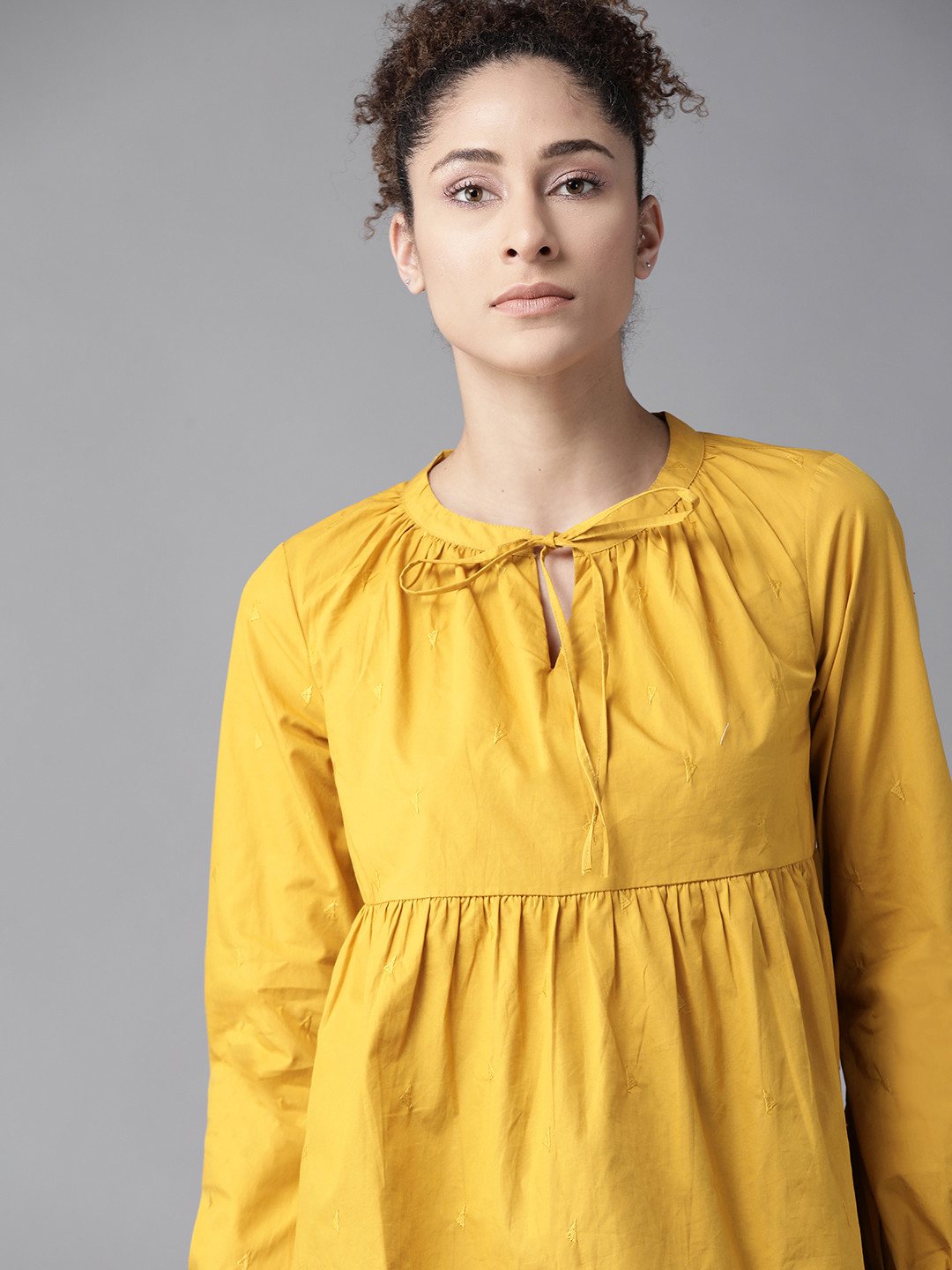 

The Roadster Lifestyle Co Mustard Yellow Pure Cotton Geometric Embroidered Tie-Up Neck A-Line Top