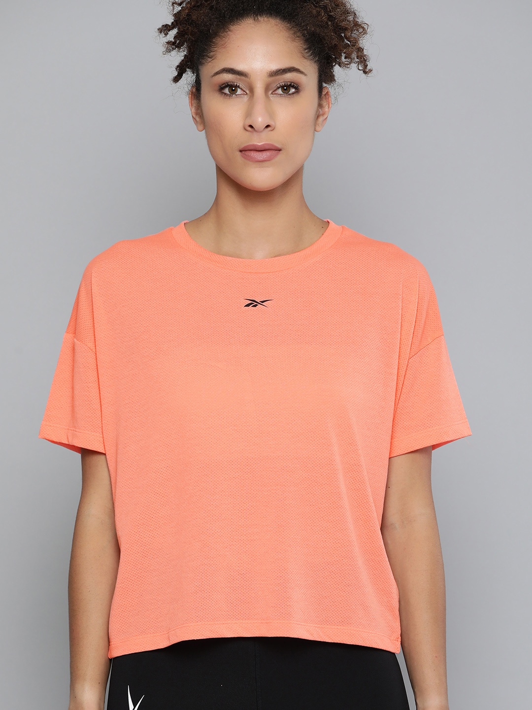 

Reebok Women Peach-Coloured Solid Workout Ready Supremium T-Shirt