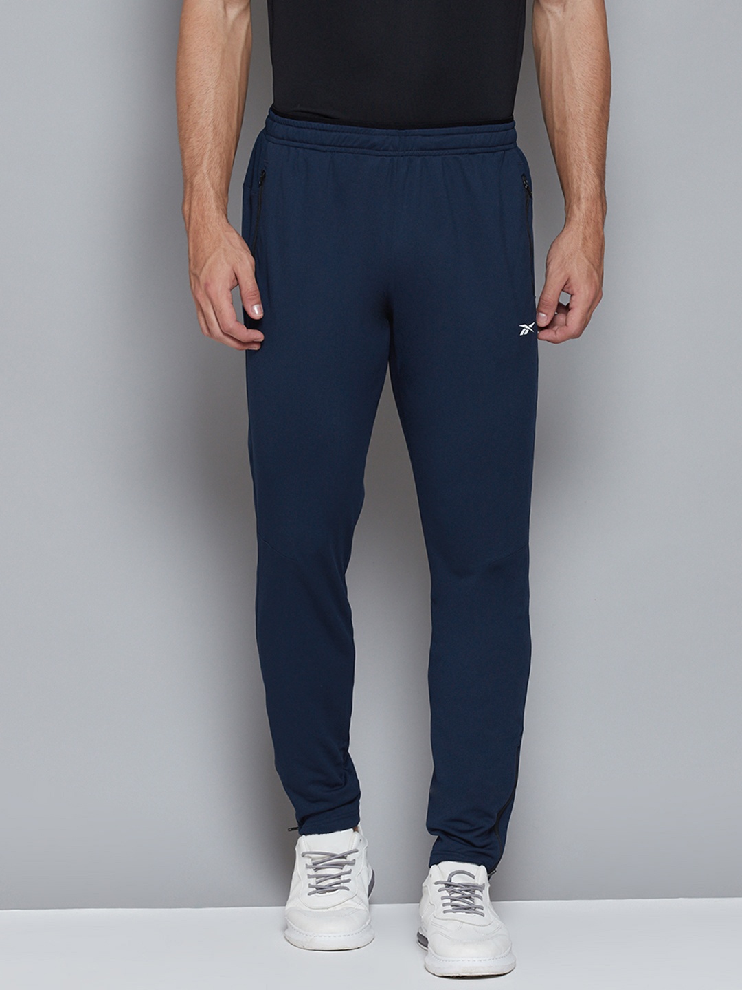 

Reebok Men Blue Workout Solid Slim Fit Training Track Pants, Navy blue