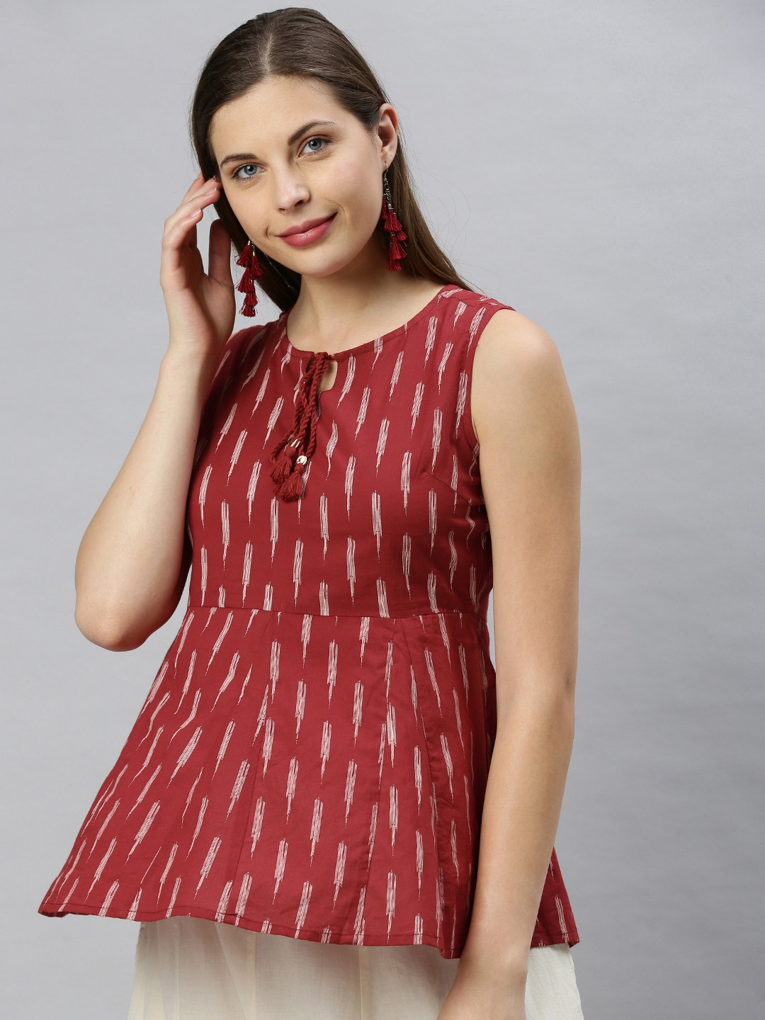 

Janasya Maroon Geometric Printed Tie-Up Neck Peplum Top