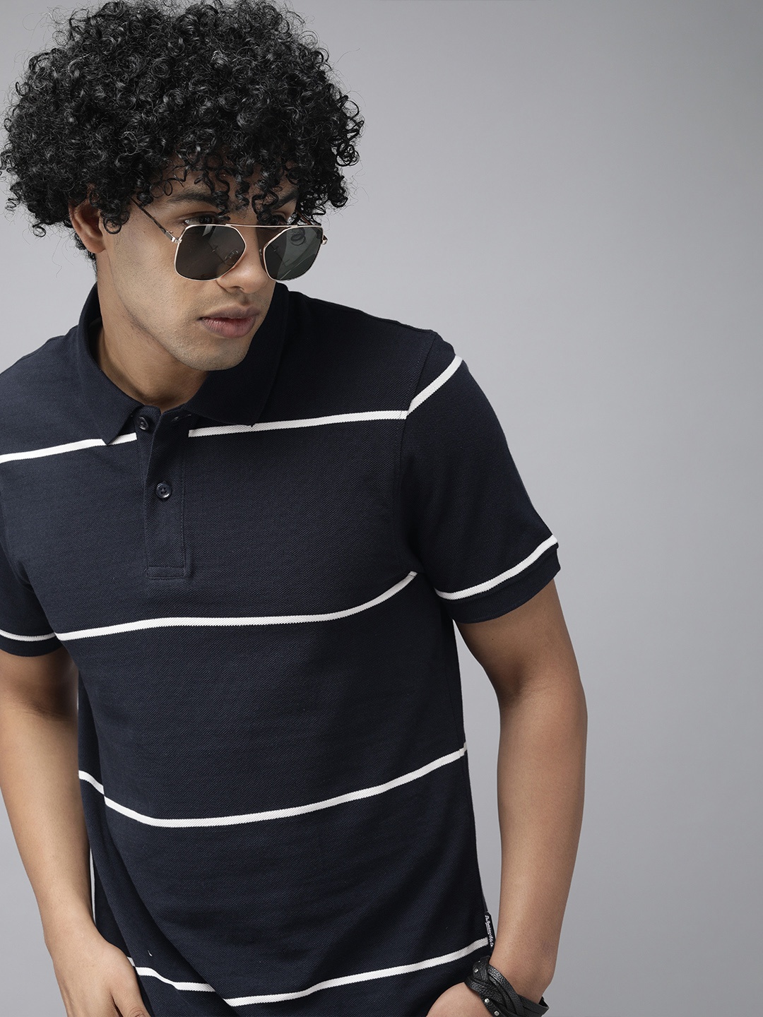 

The Roadster Lifestyle Co Men Navy Blue White Striped Pure Cotton Polo Collar Pure Cotton T-shirt