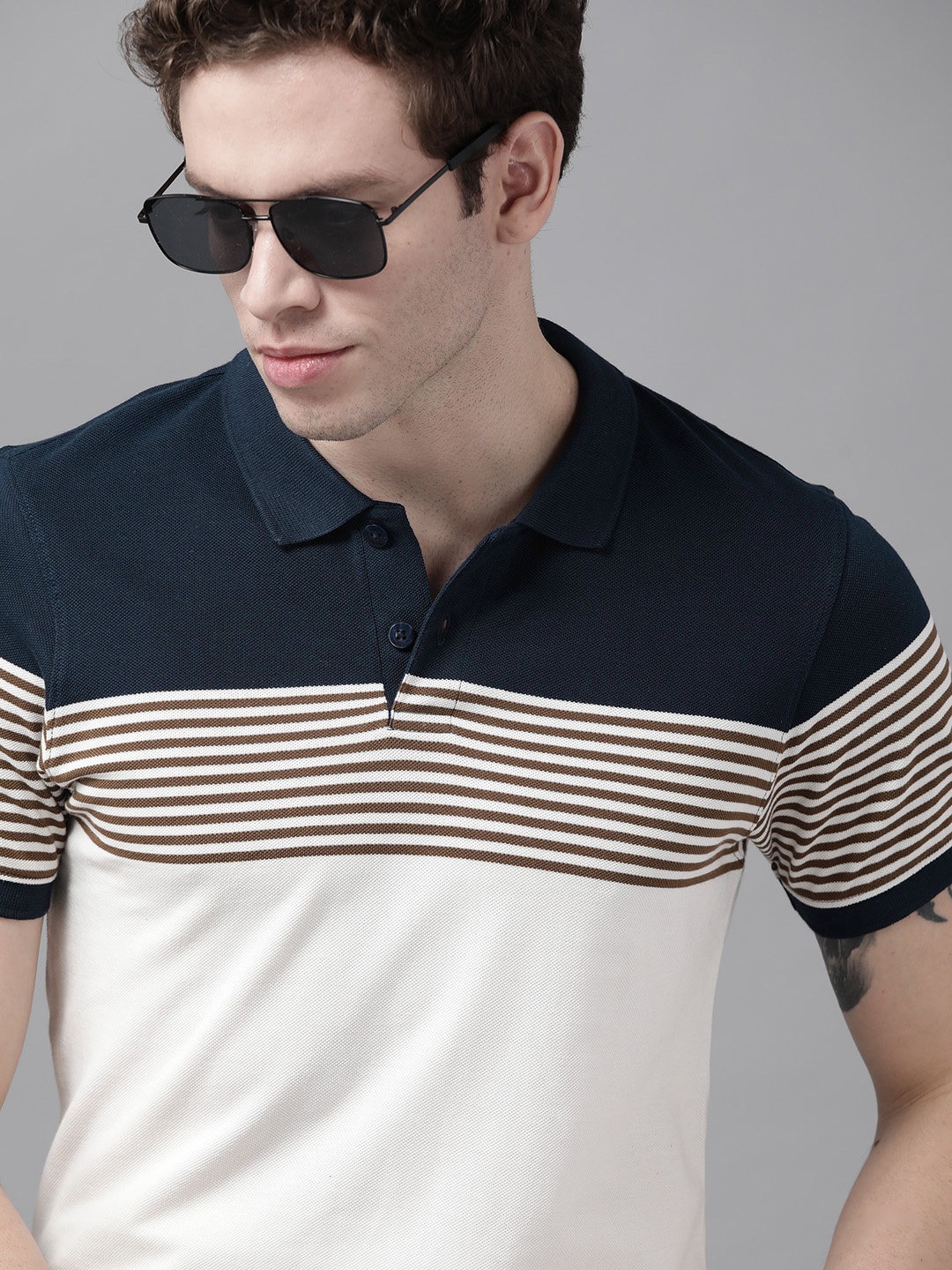 

Roadster Men Off White & Navy Blue Striped Polo Collar Pure Cotton T-shirt