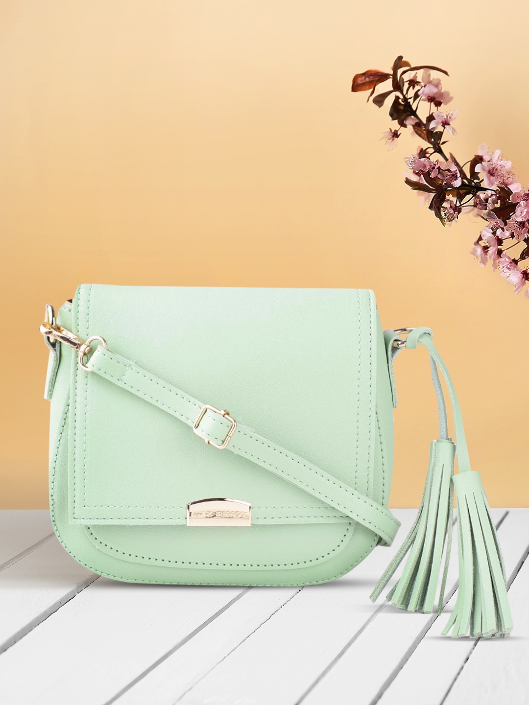 

Lino Perros Women Green Solid Sling Bag with Tasselled Detail