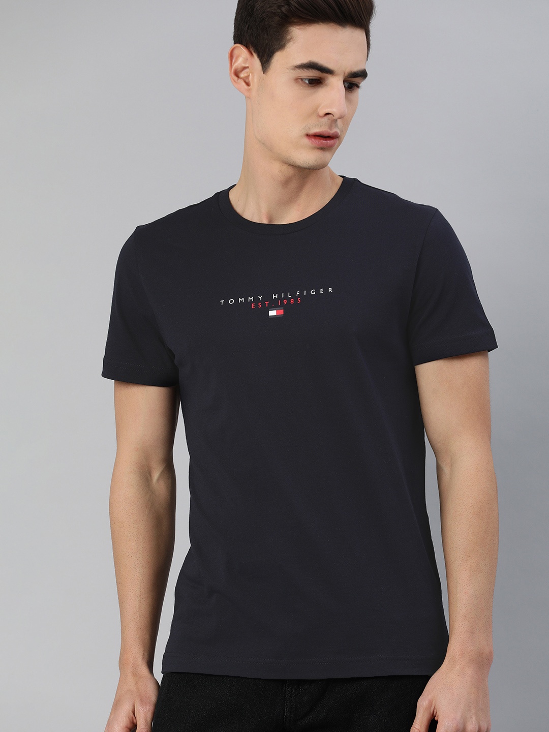 

Tommy Hilfiger Men Navy Blue Solid Round Neck Organic Cotton Pure Cotton T-shirt with Logo Print