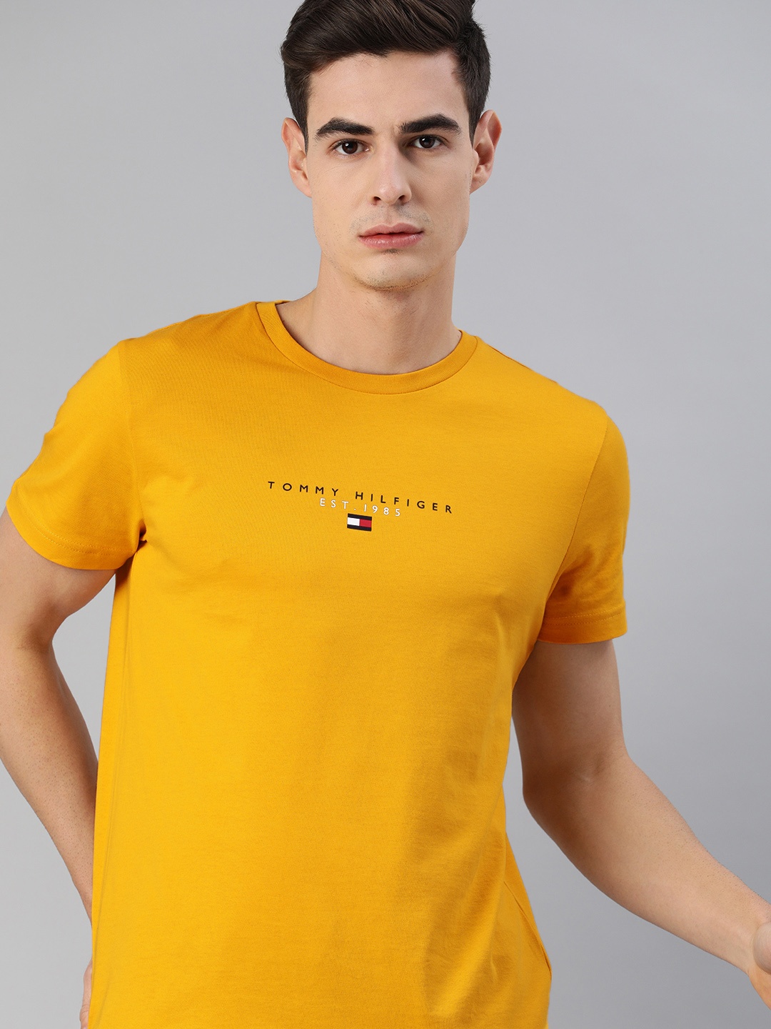 

Tommy Hilfiger Men Mustard Yellow Solid Round Neck Organic Cotton T-shirt with Logo Print