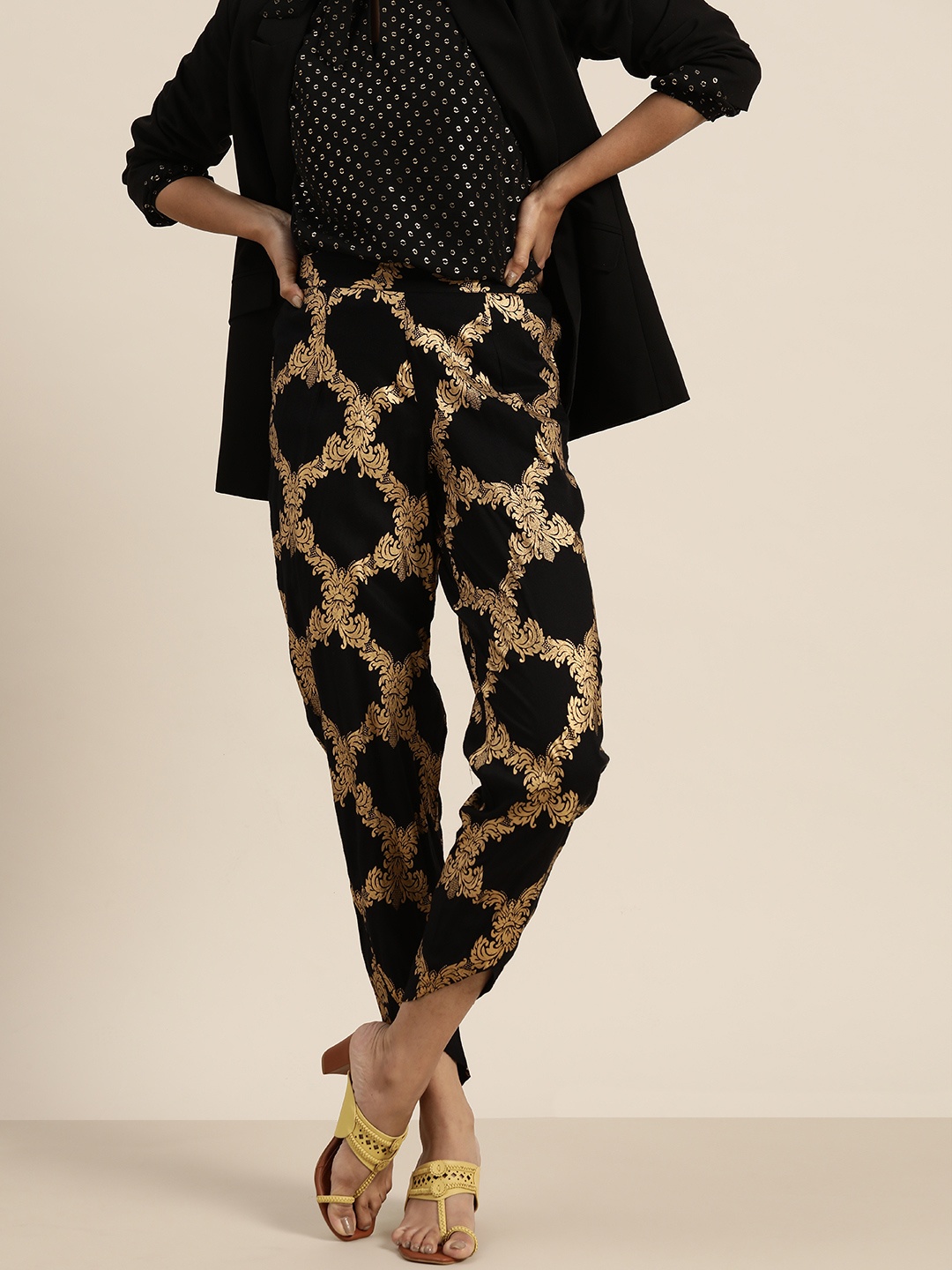 

Shae by SASSAFRAS Women Black & Golden Regular Fit Foil Printed Trousers