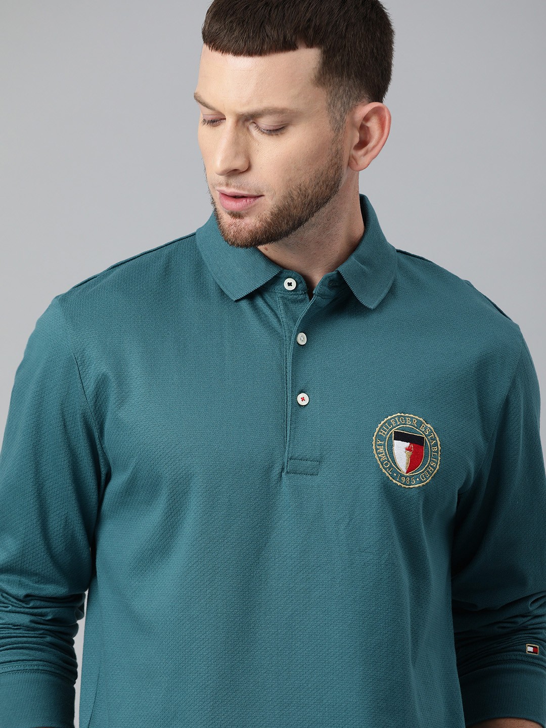 

Tommy Hilfiger Men Teal Blue Self Design Polo Collar Pure Cotton T-shirt with Logo