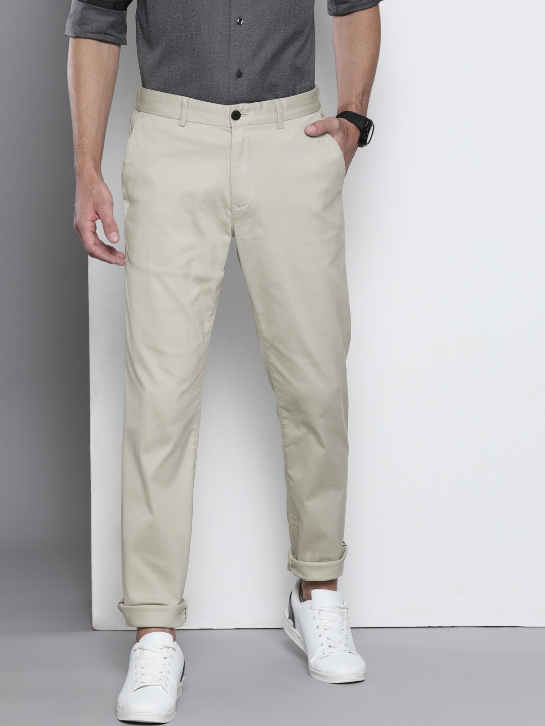 

Tommy Hilfiger Men Beige Tapered Fit Solid Regular Trousers