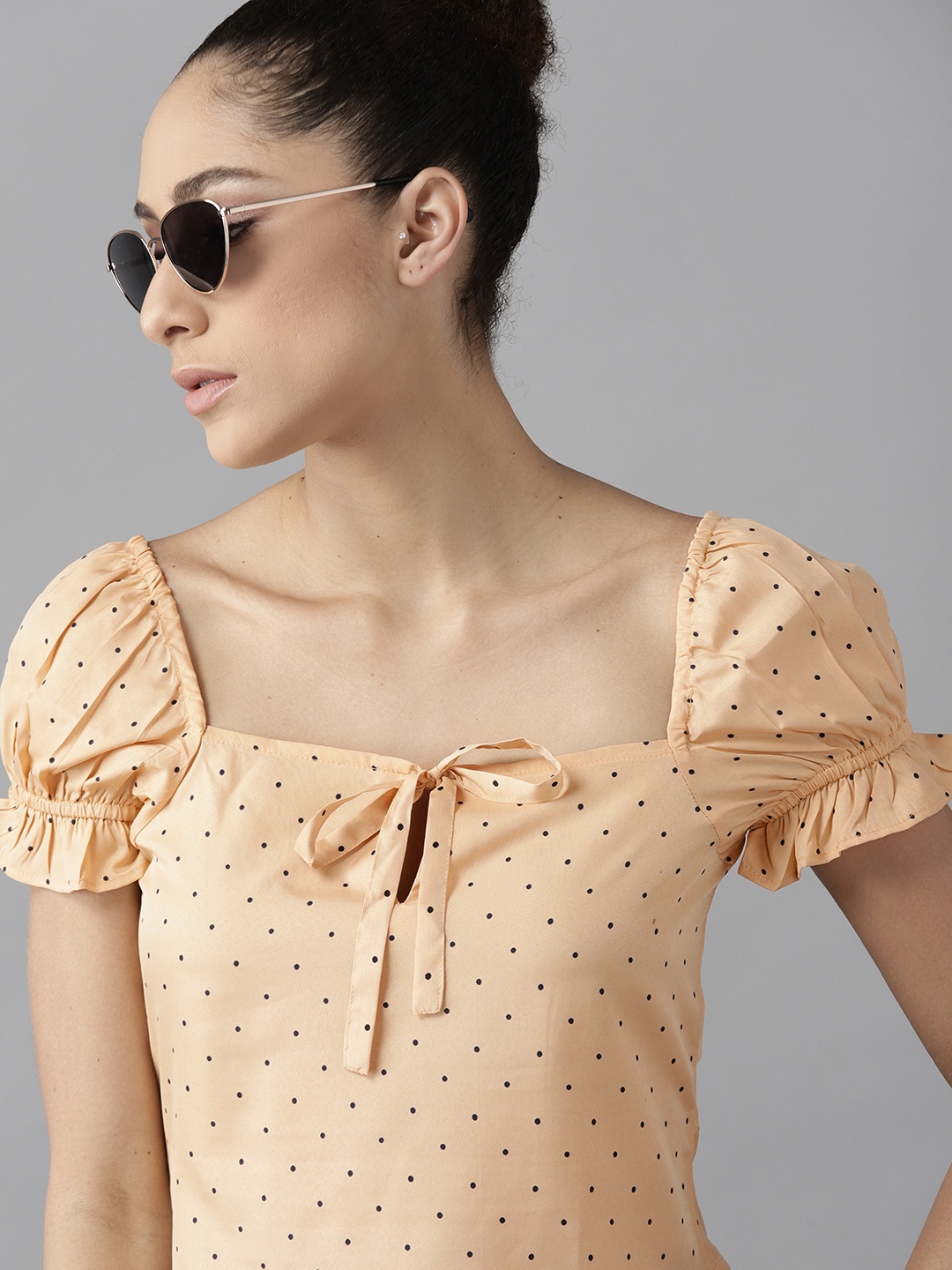

Roadster Women Beige & Black Polka Dots Print Tie-Up Neck Regular Top
