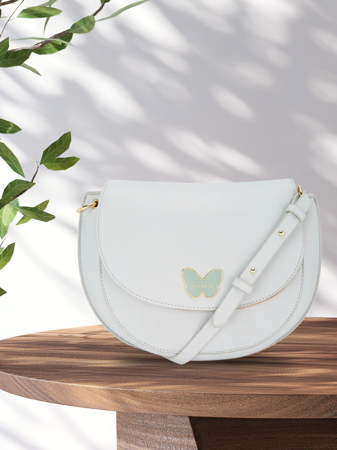 

Caprese Grey PU Half Moon Sling Bag with Applique