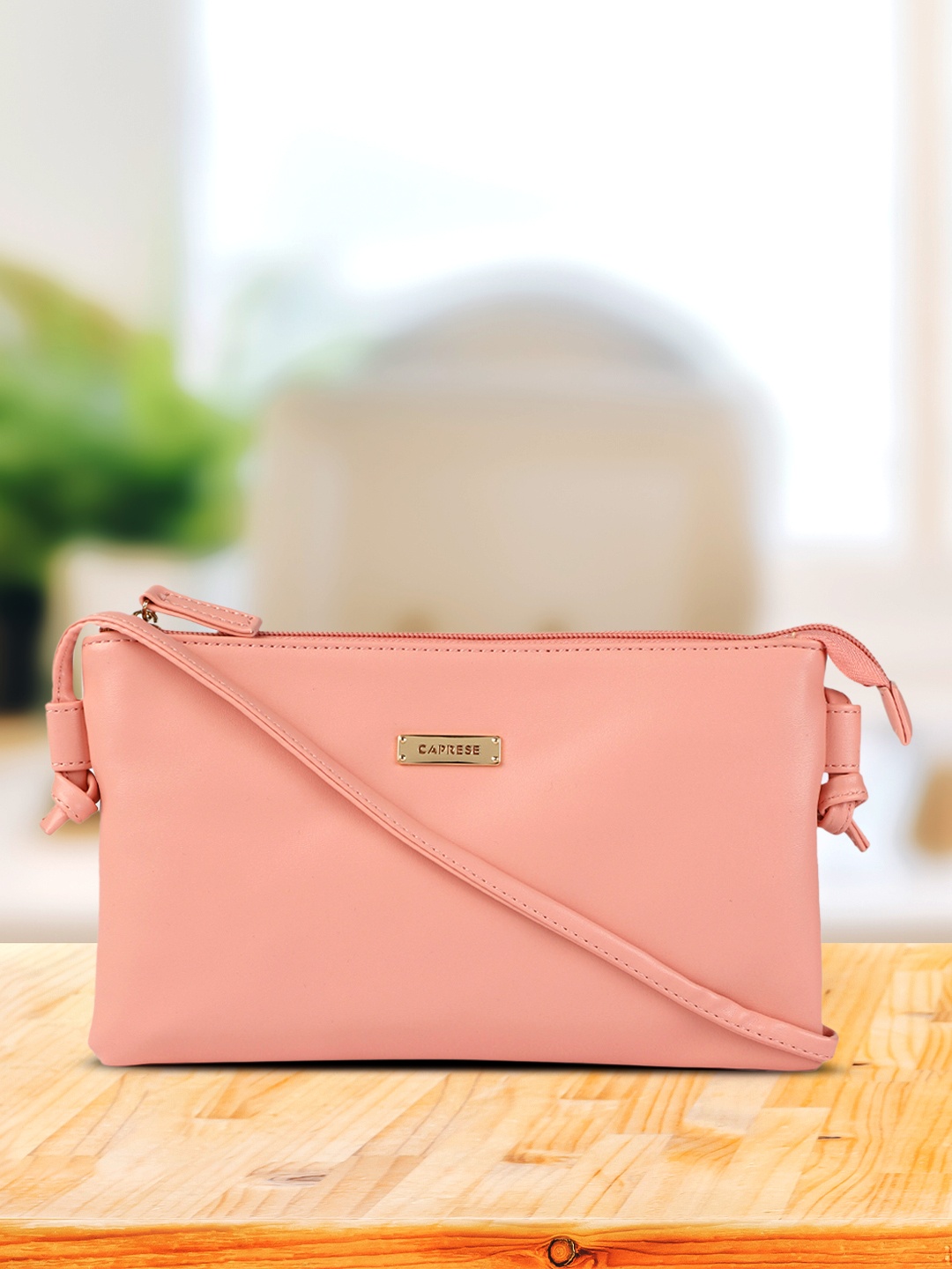 

Caprese Pink Leather Structured Sling Bag